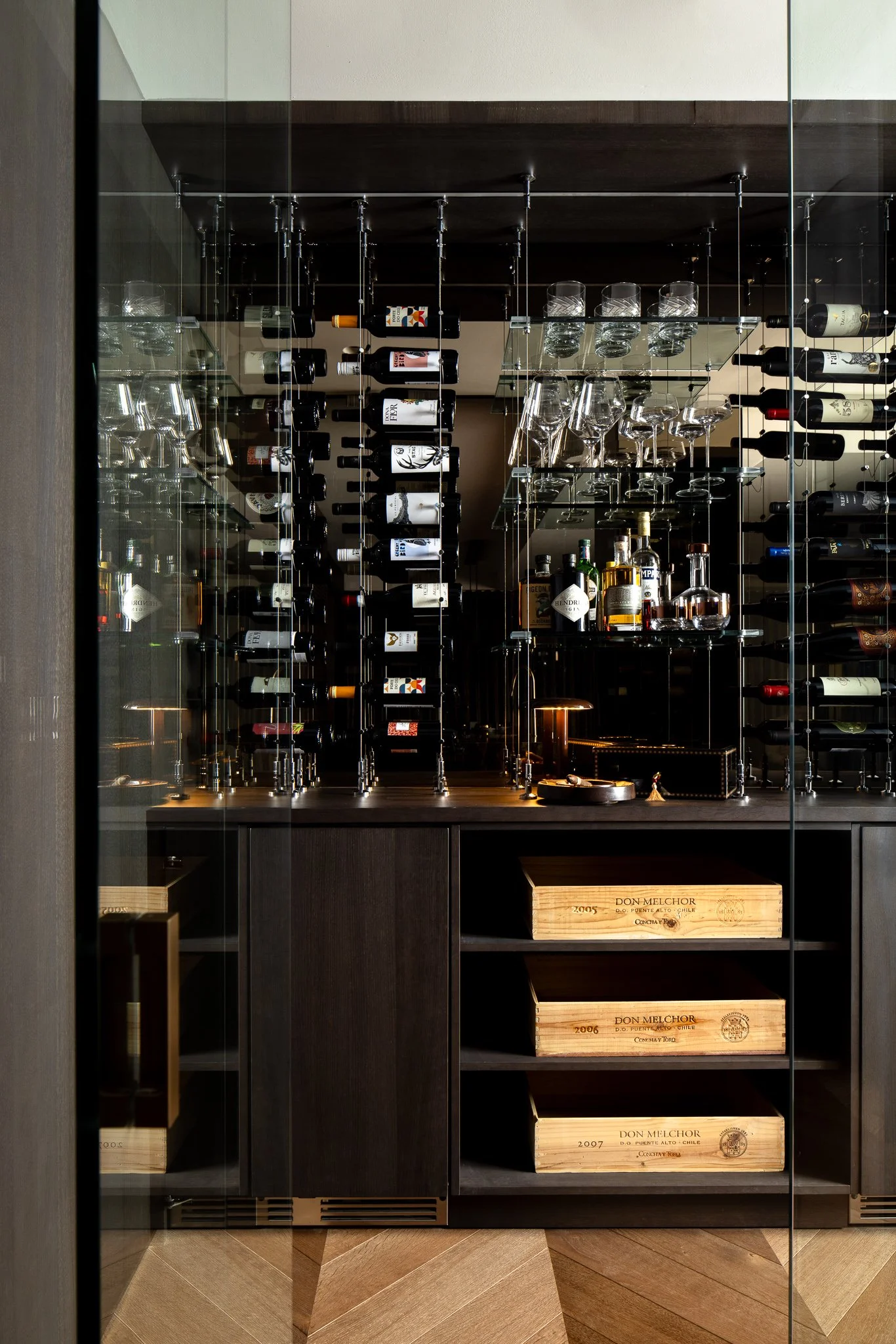 glass wine room with cable wine storage system and suspended glass shelving in Rittenhouse Square Philadelphia home