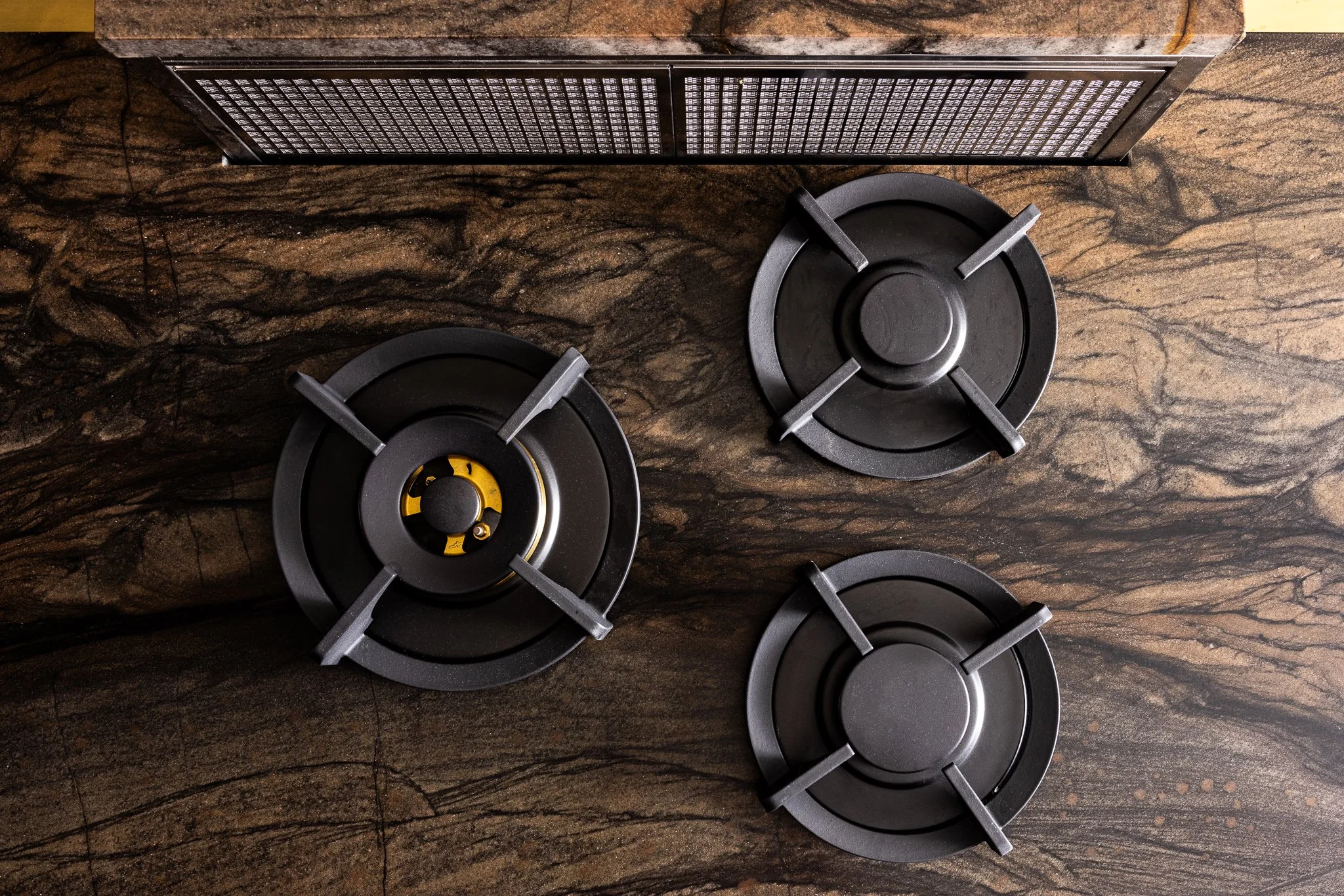 kitchen island design with integrated flush gas burners modern cooktop detail and custom cabinetry layout