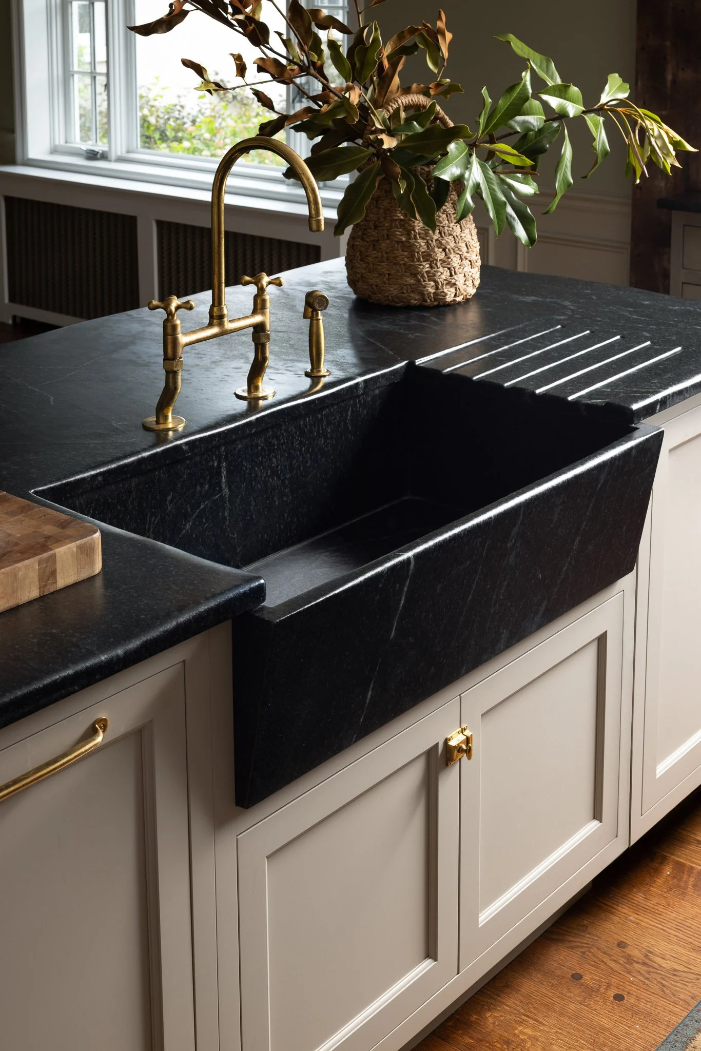 kitchen cabinetry with farmhouse apron sink soapstone countertop inset cabinets painted finish traditional design