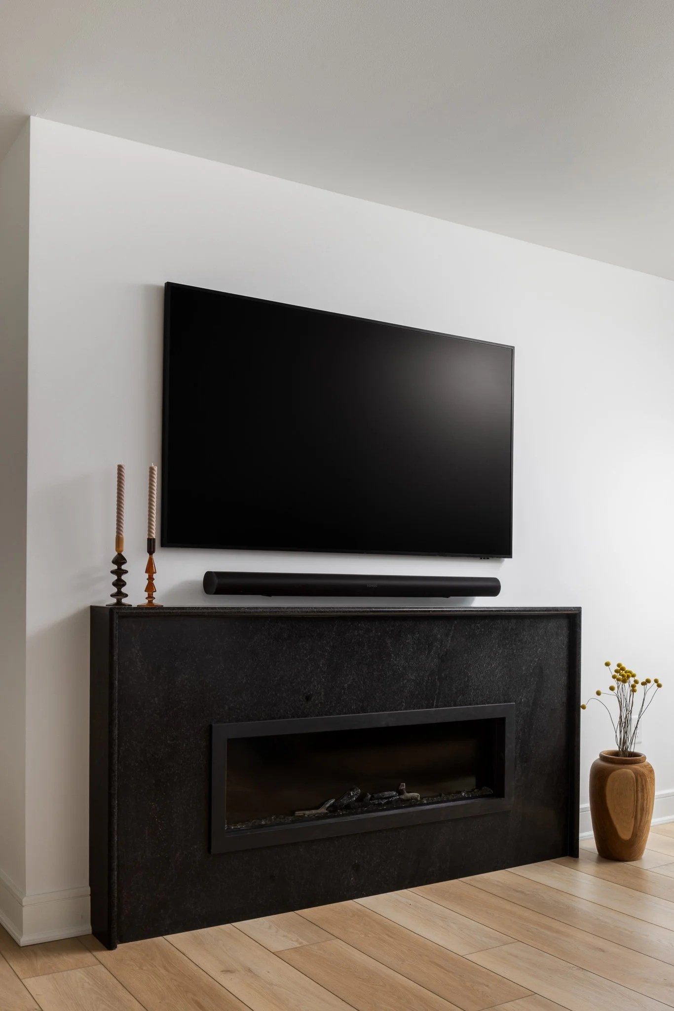 living room with granite fireplace surround and wall mounted television philadelphia interior design