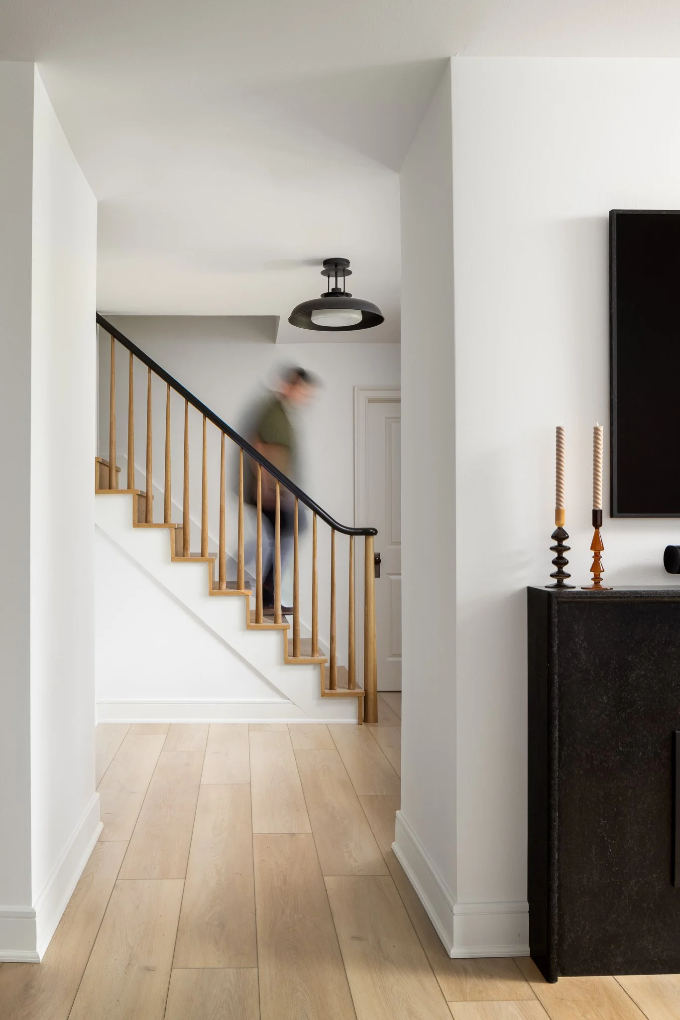 white oak staircase with black handrail and light wood flooring philadelphia residential design