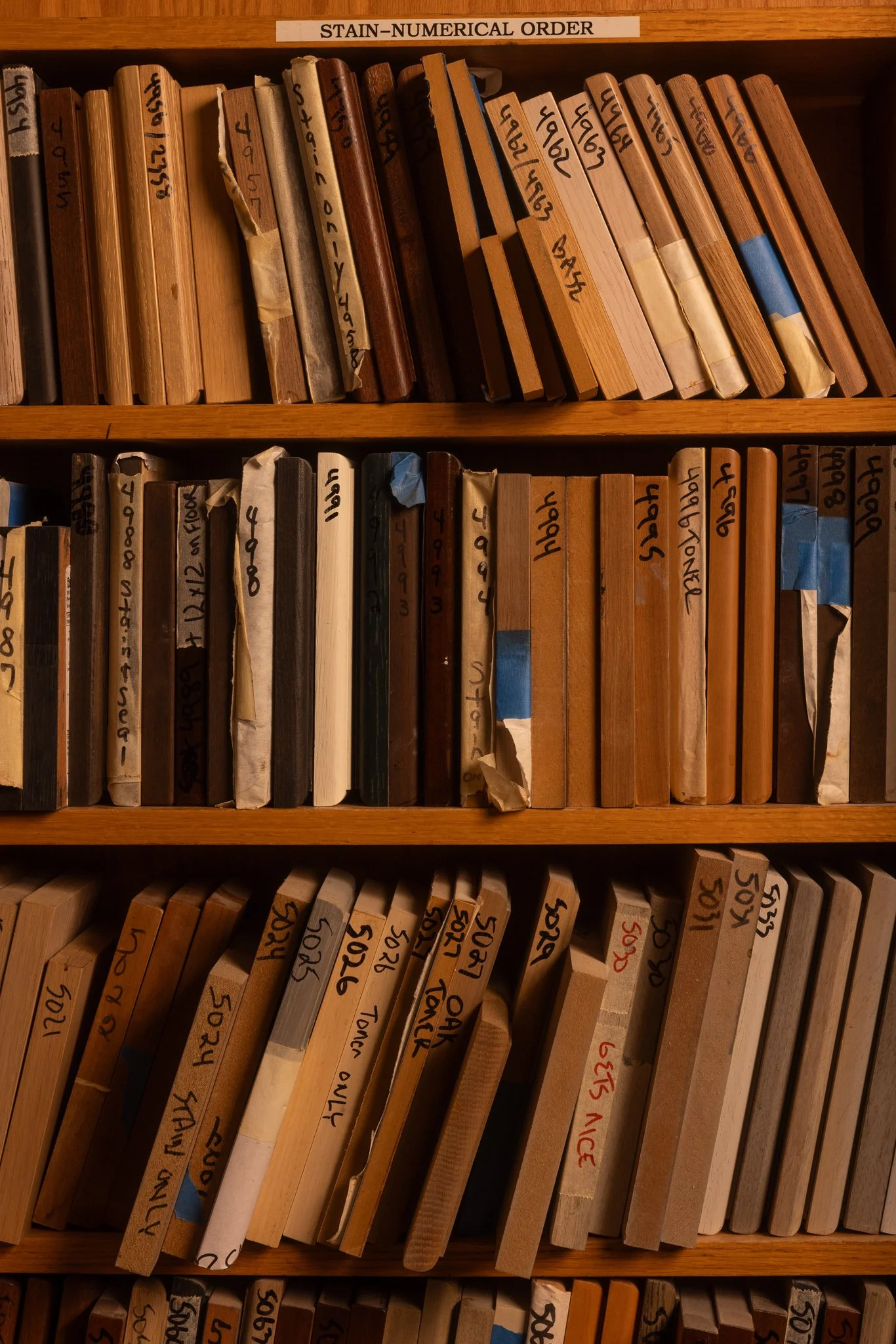 home library cabinetry with custom wood shelving built in bookcases warm wood finish integrated lighting