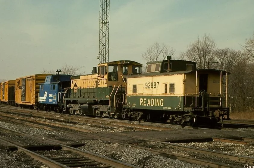 RDG SW1500 2759, soon to be CR 9598, is coupled to N4 class cabin 92887 (CR 18752) as they work Abrams yard in February, 1977. Photo by Alan Page. Courtesy of the Conrail Historical Society