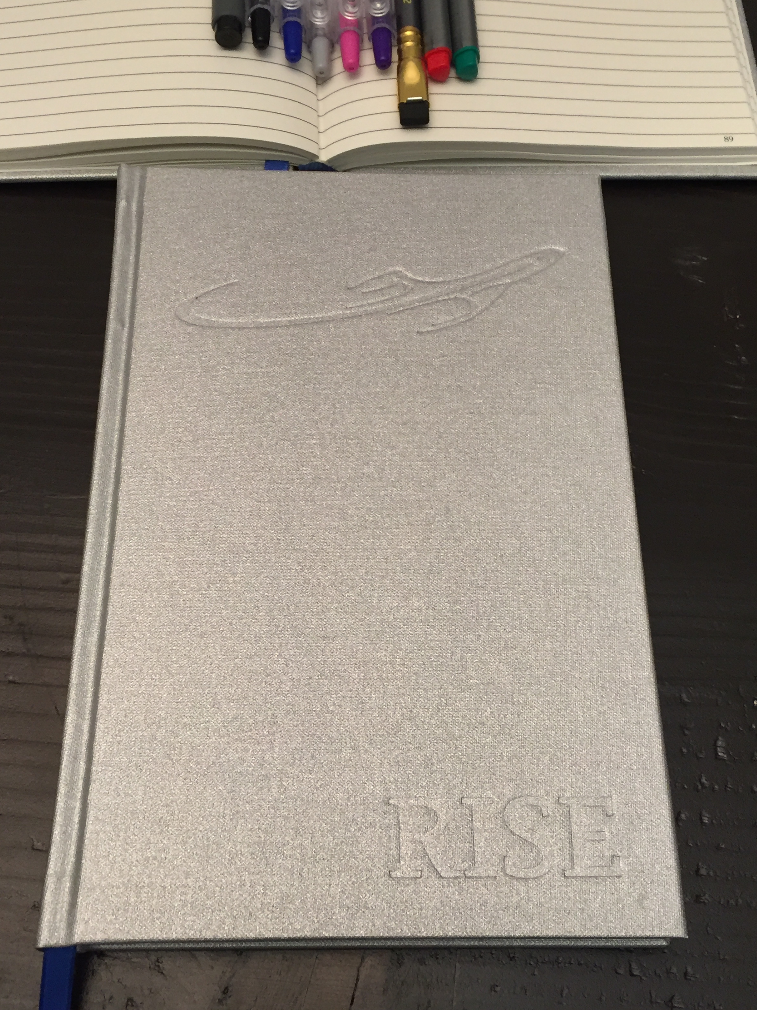 Exterior Cover of Rise , the notebook for people who are going places. Hardcover ruled notebooks offer a premium writing experience without the use of a flat, hard surface.