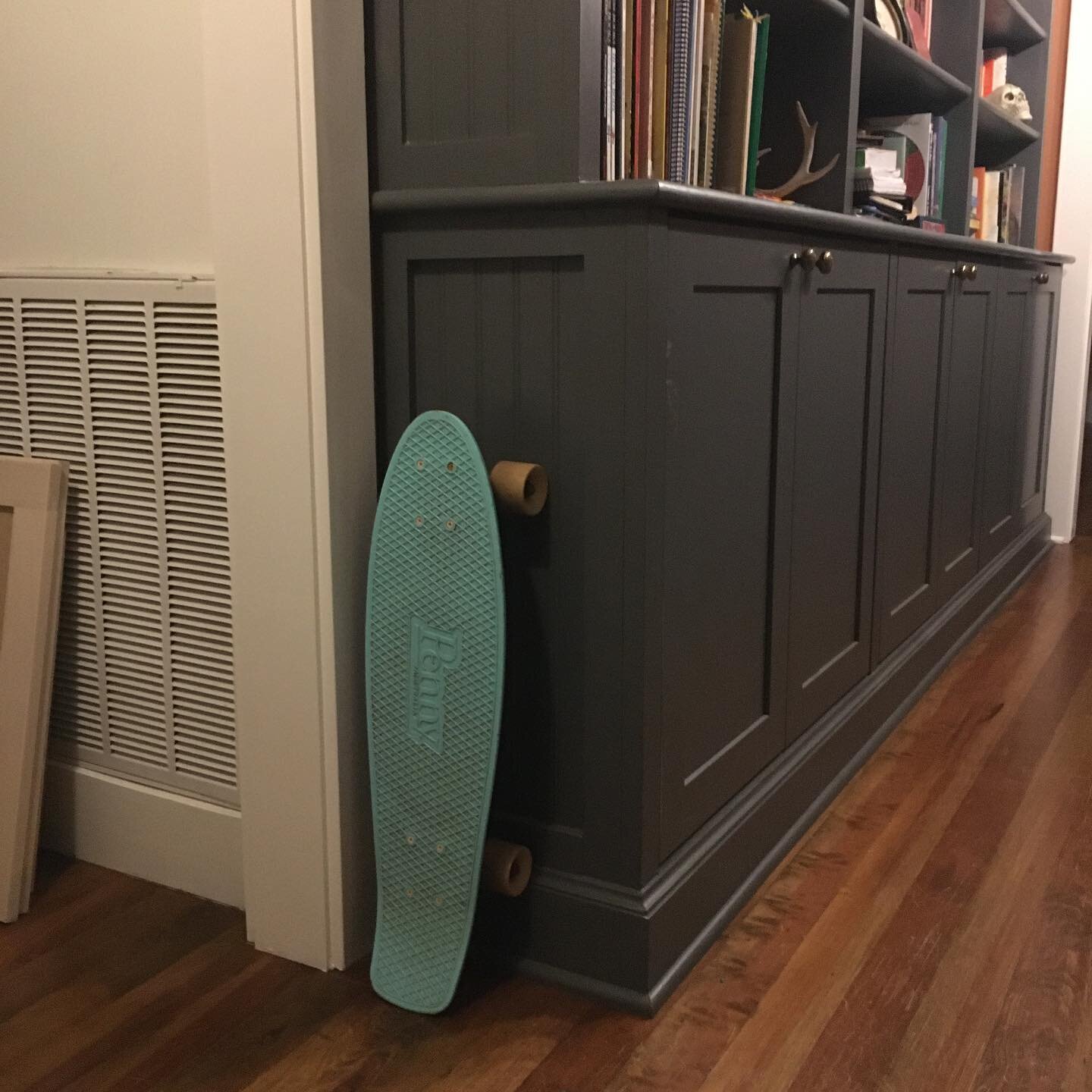 This is our life.  #custombookcase With #vintage #heartofpine  #floors with a #skateboard propped up where the youngest left it.  #life is good.