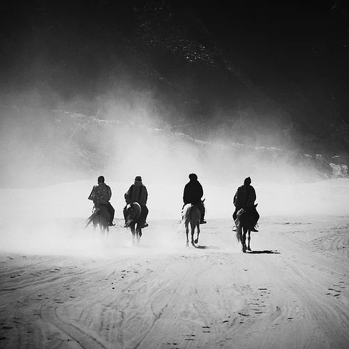 riders_on_horseback_in_black_and_white.jpg