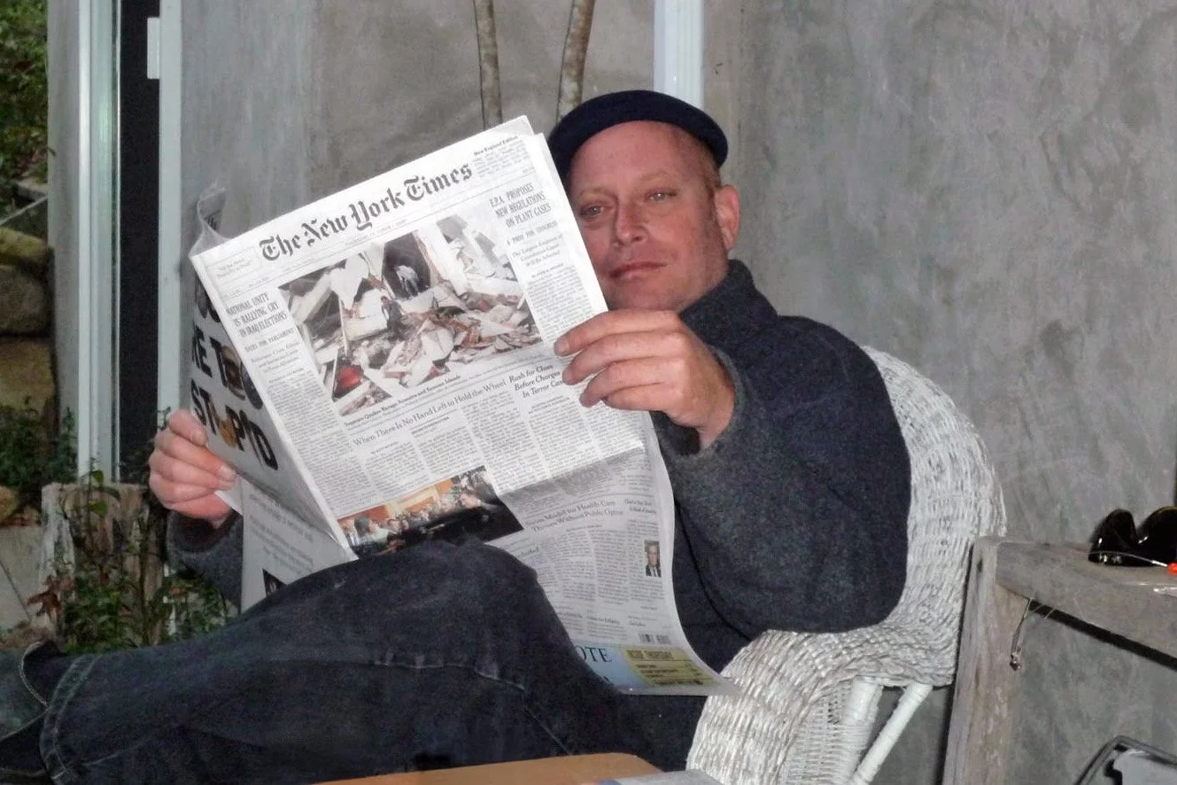 Mark Sweeney, the artist sitting reading the NY Times.