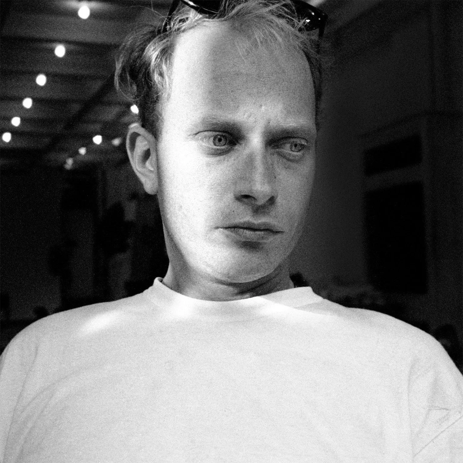 Black-and-white portrait photograph of artist Mark Sweeney.