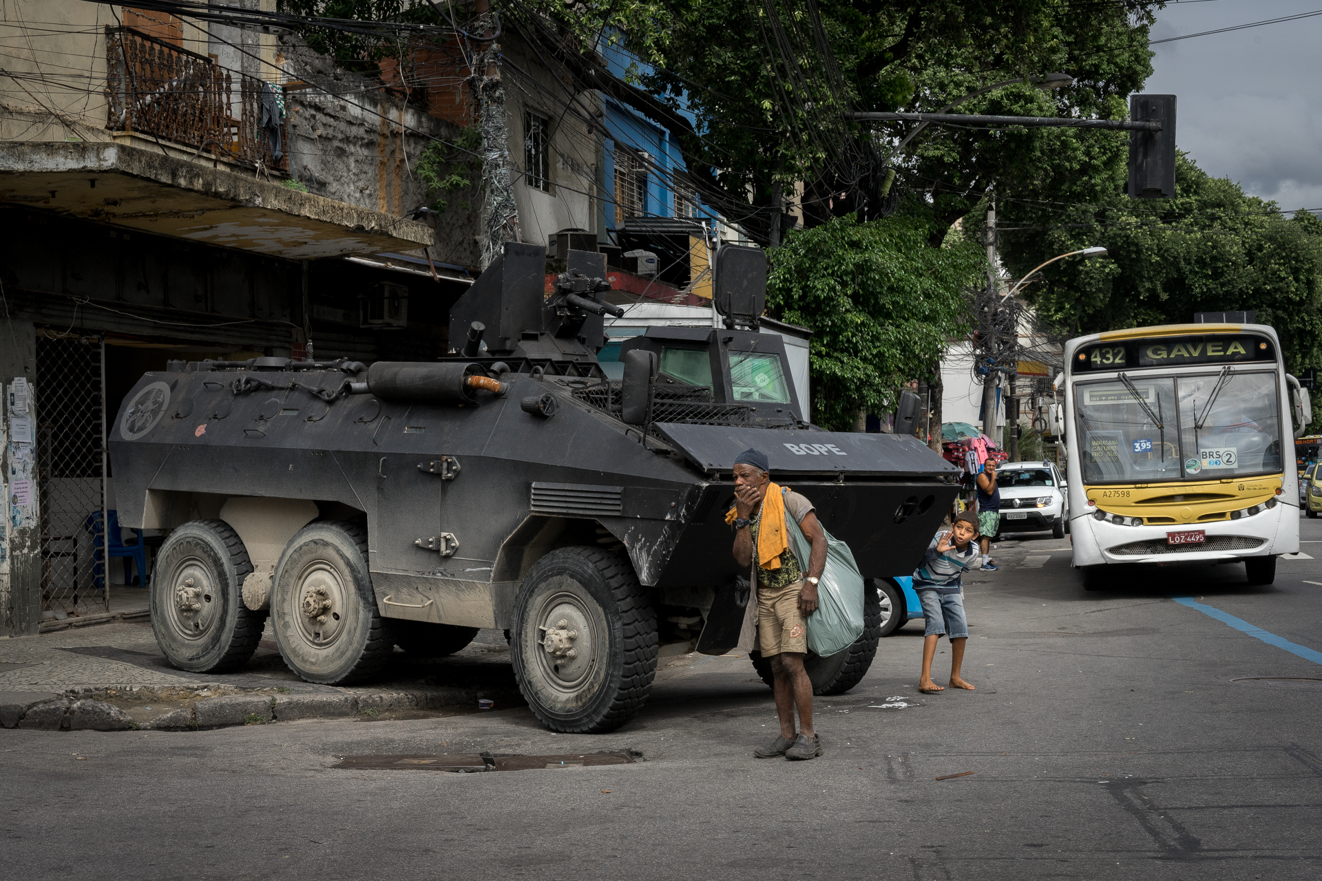 A boy uses an APC belonging to the BOPE special operations unit as a prop to tease a homeless man during a police operation in Rio de Janeiro, August 8, 2018.