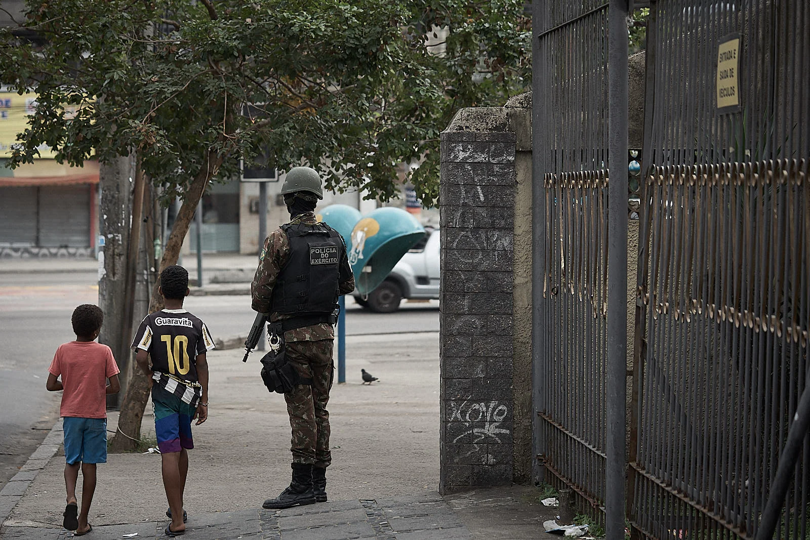 A Brazilian soldier, part of the federal intervention, guards a street during an operation against narcotics factions. The government says that policy decisions like these operations are what has caused a recent drop in crime. (Photo: C.H. Gardiner)