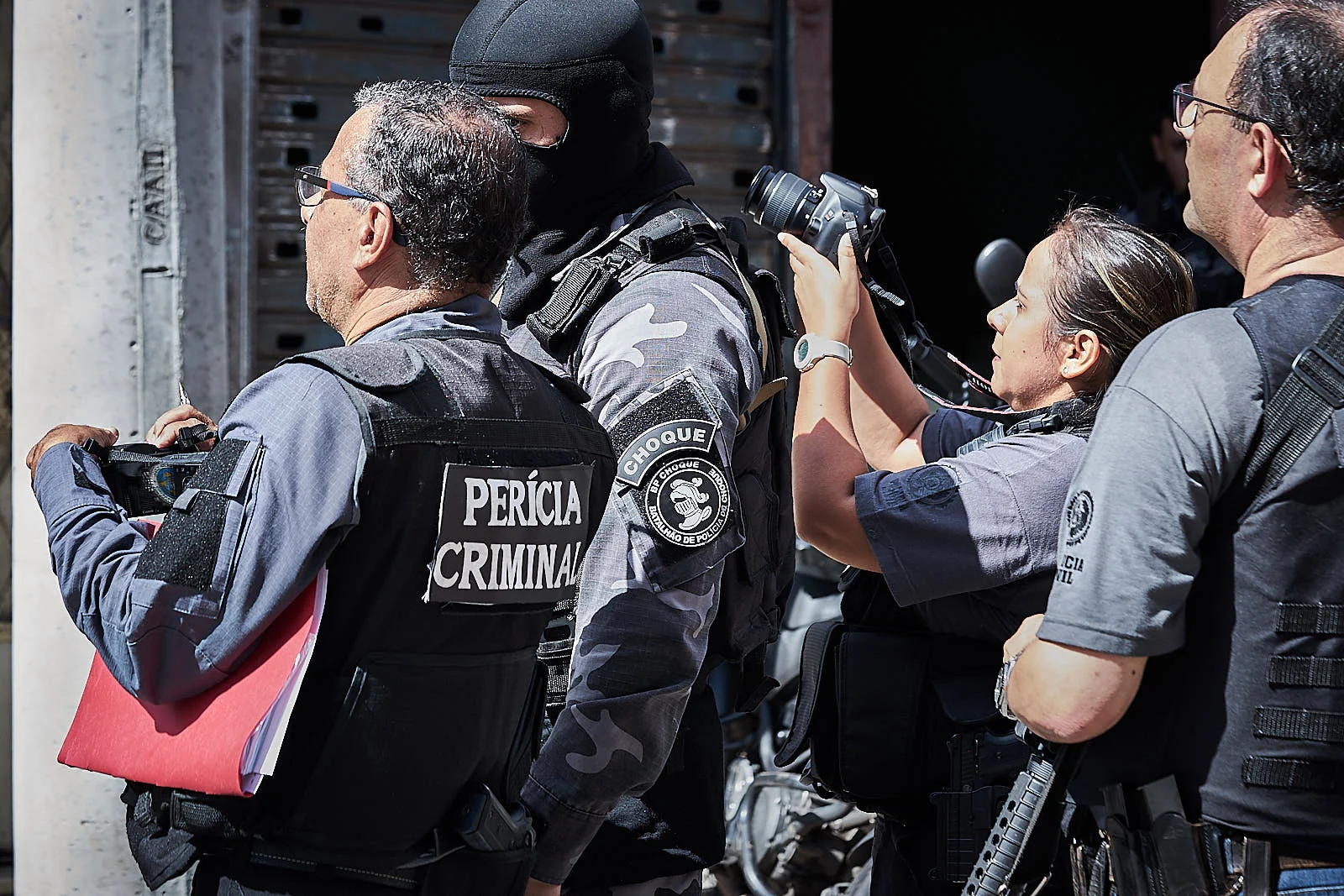 A member of Rio's Choque battalion guides investigators through the events that happened leading up to the killing of nine alleged traffickers in a house in Rio de Janeiro. (Photo C.H. Gardiner)