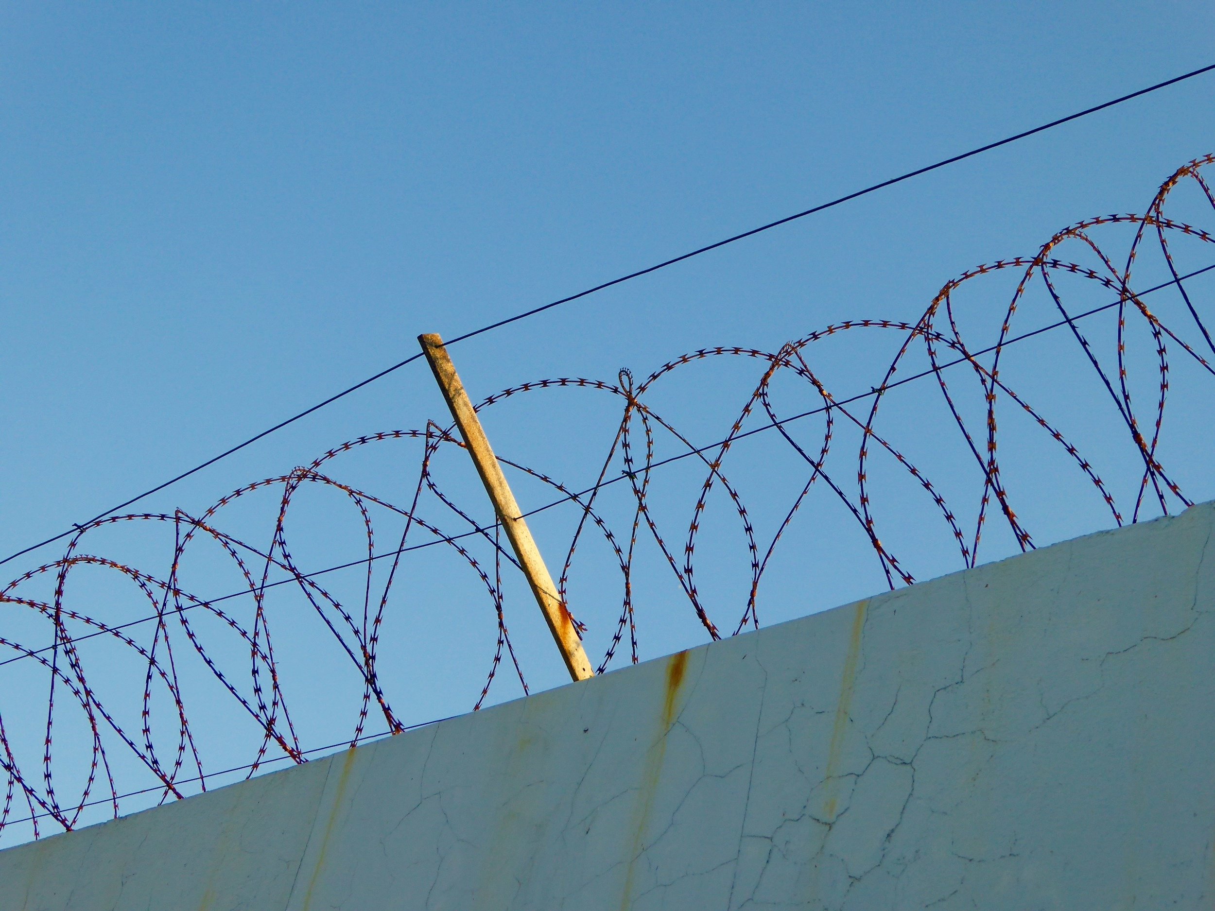  barbed wire fence on the minimum security prison at sunrise&nbsp; 