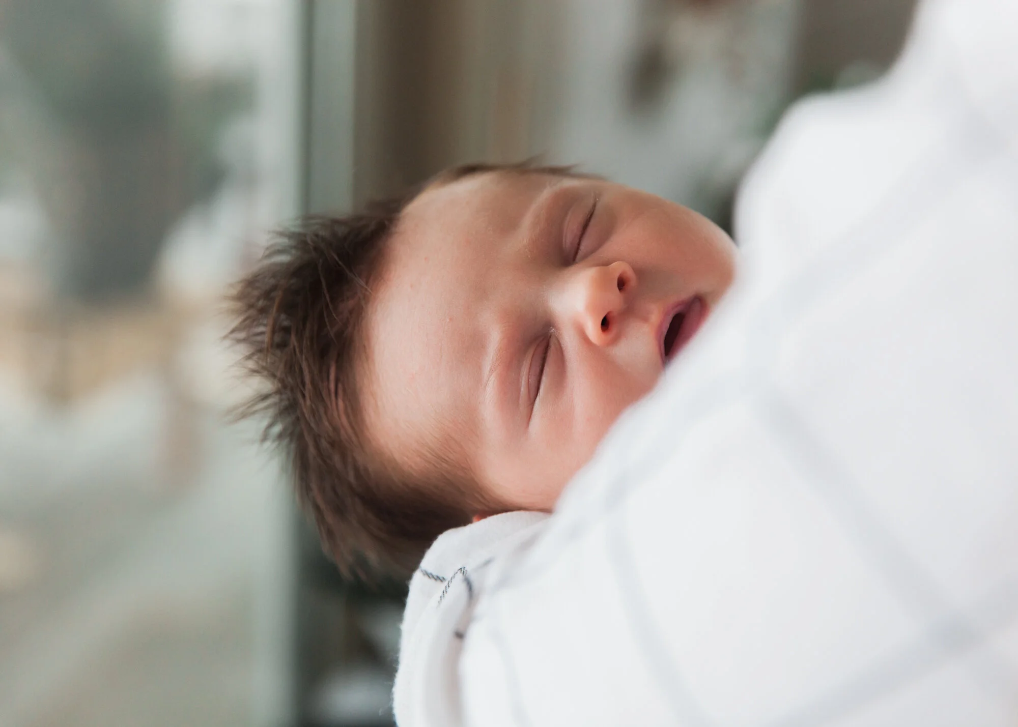 face of newborn baby with dark hair