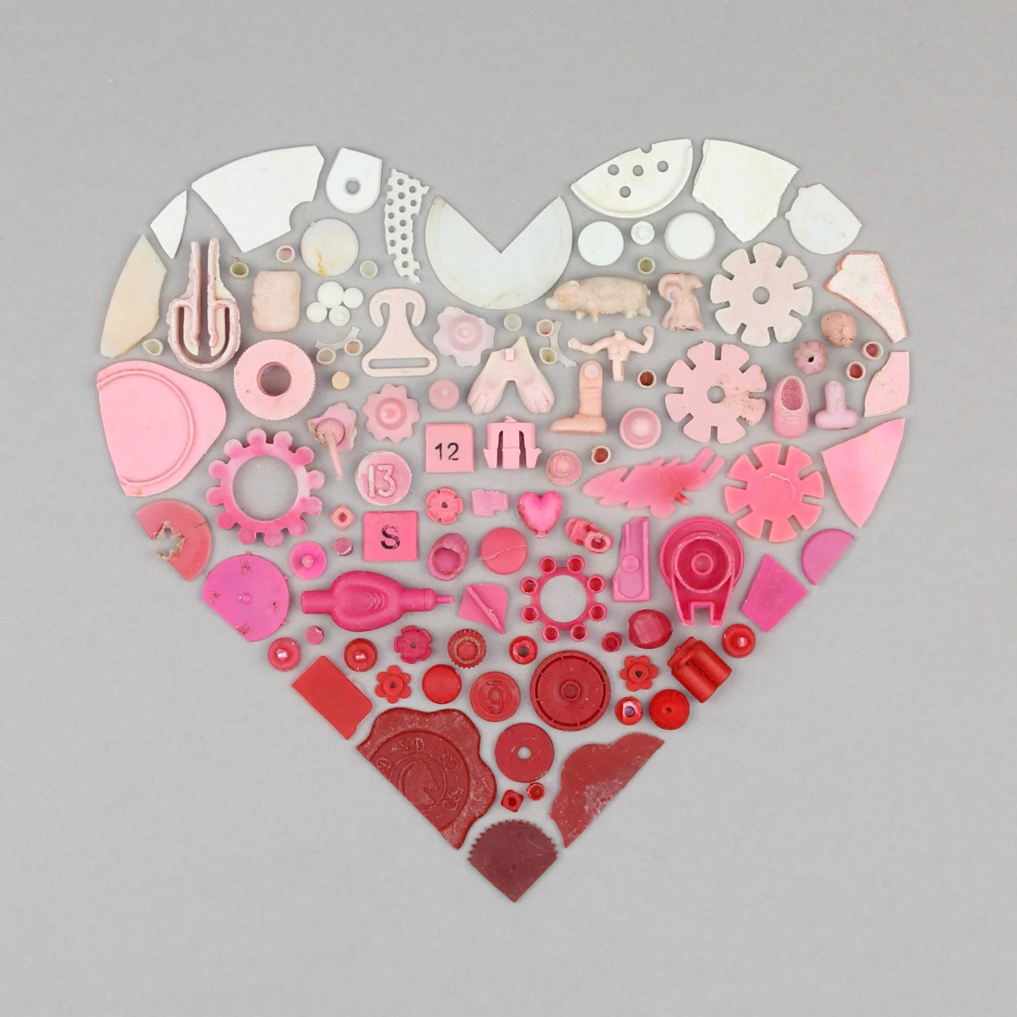  A heart of red, pink and white beach plastic 
