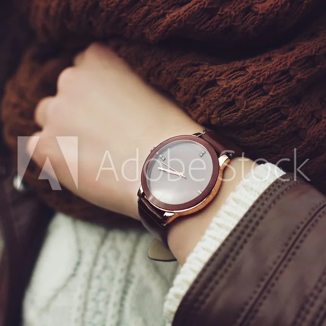 Elegantoutfit.Closeupofbrownwristwatchonthehandofstylishwoman.Fashionablegirlonthestreet.Femalefashion.Toned.jpg