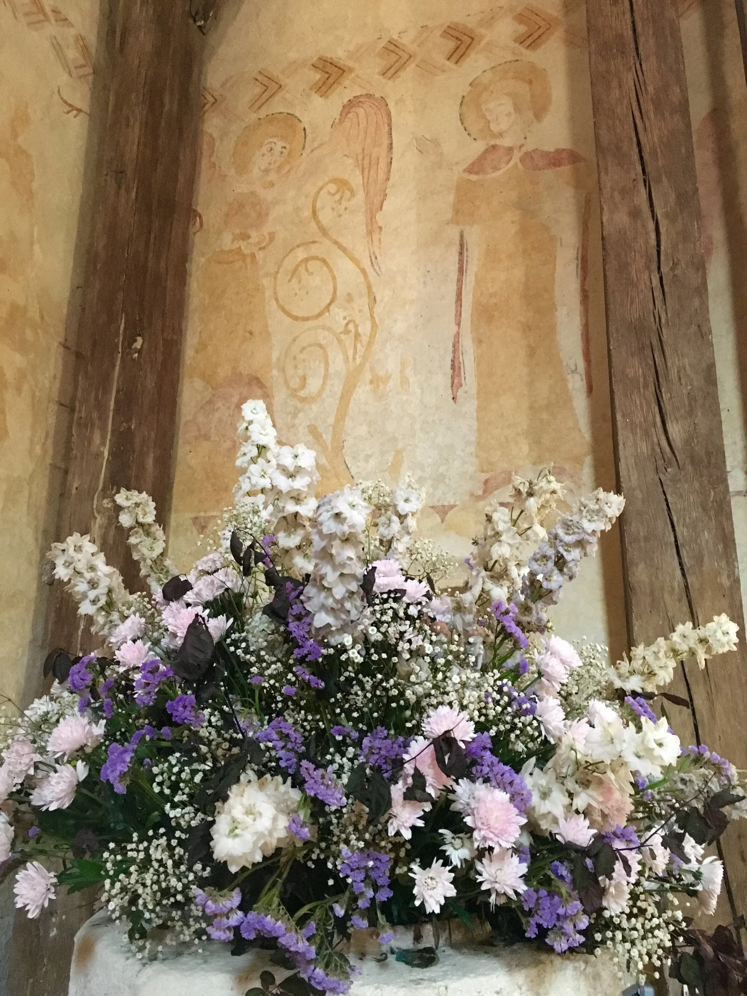 Fresh flowers graced Eglise St. Pierre the day we visited. Above, the Annunciation in a 12th century fresco. (photograph J. Cook)