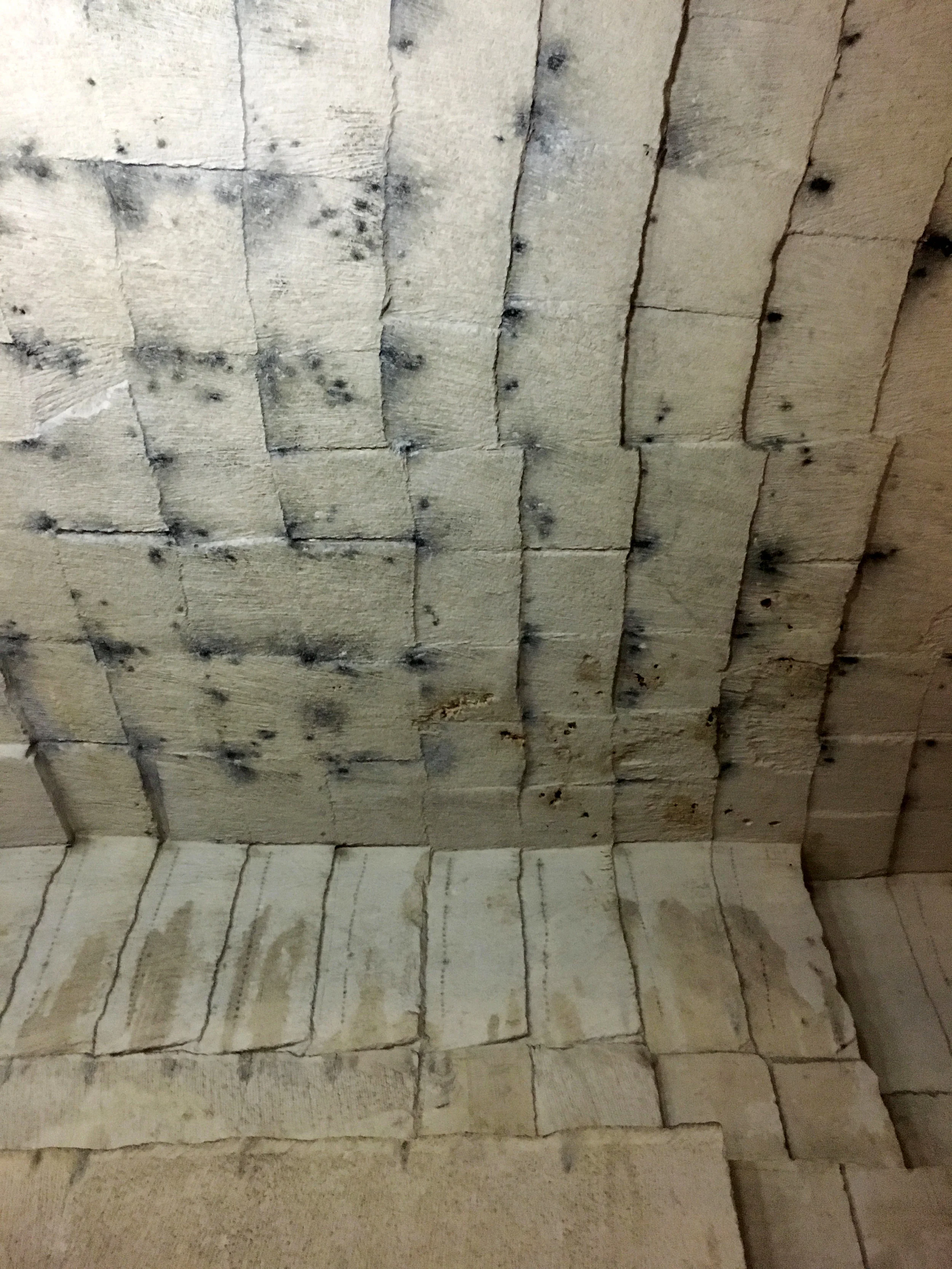 Another view with the patterns of blocks cut out, the smoke-blackened ceiling and the great height of the Quarry chamber (photograph J. Cook)