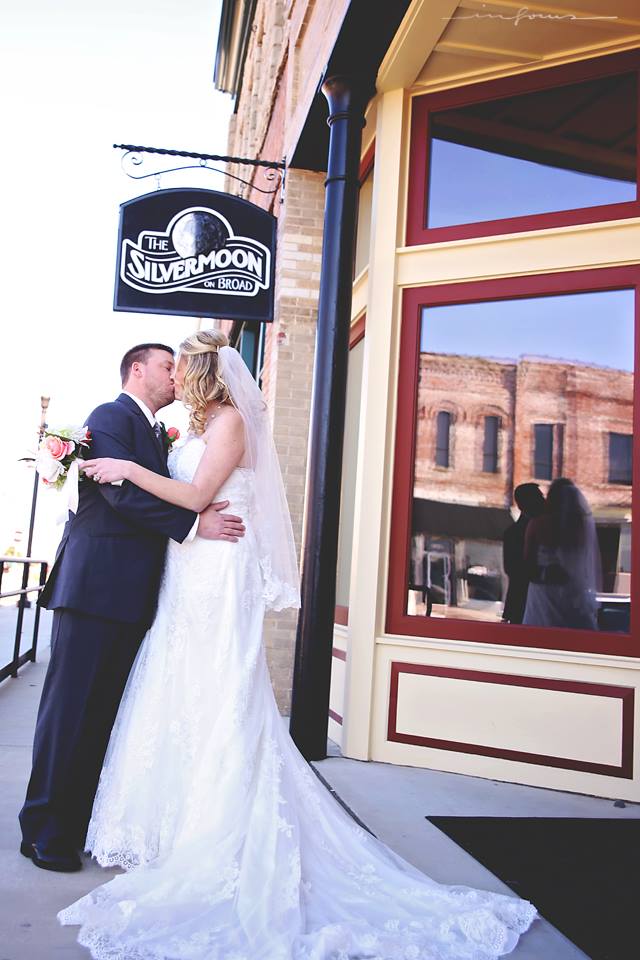 Landreth Kiss Under Sign.jpg