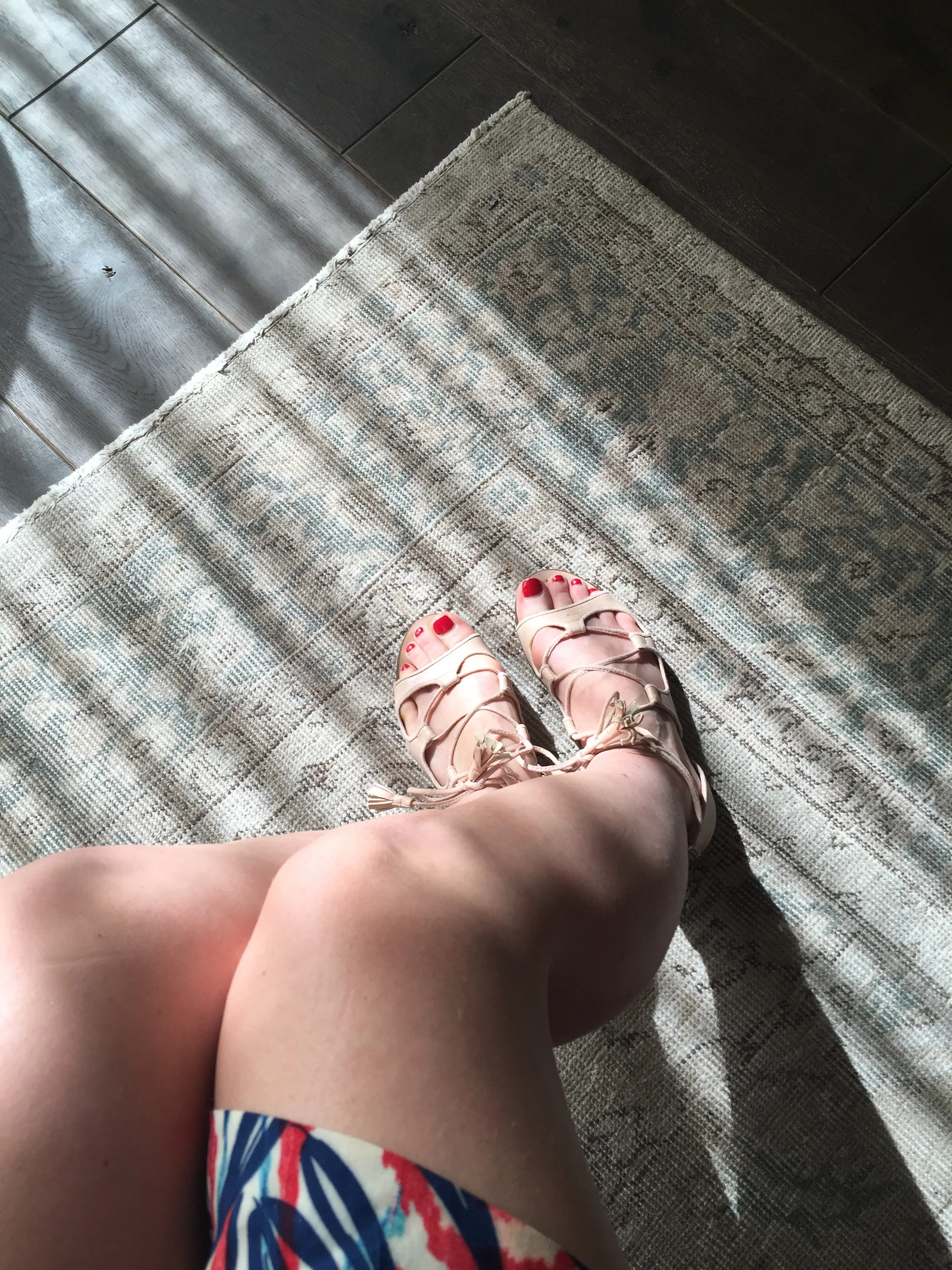 Sunlight, floorboards, lovely minty green rug and some disembodied legs