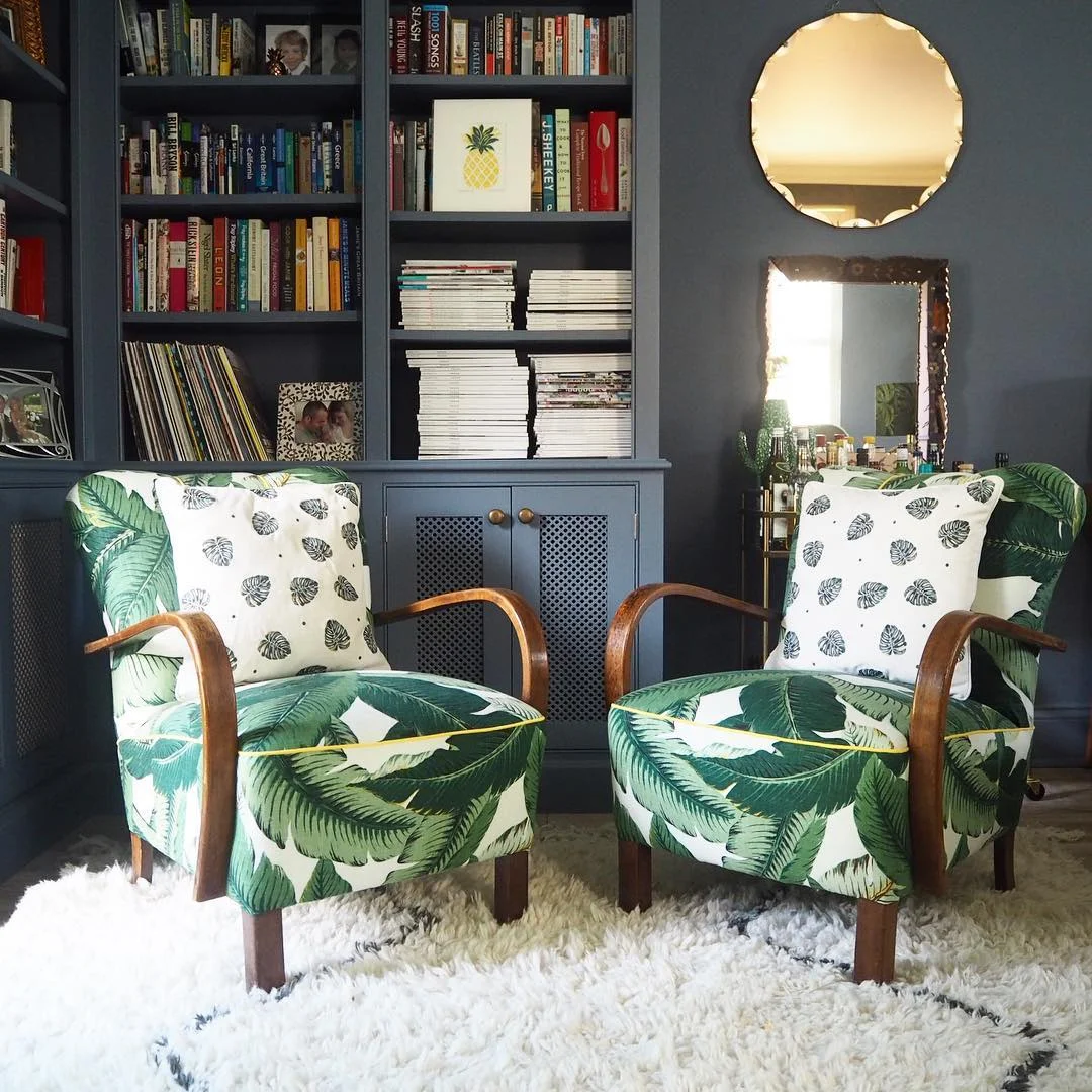 Mid-Century cocktail chairs which were recovered in banana leaf palm fabric