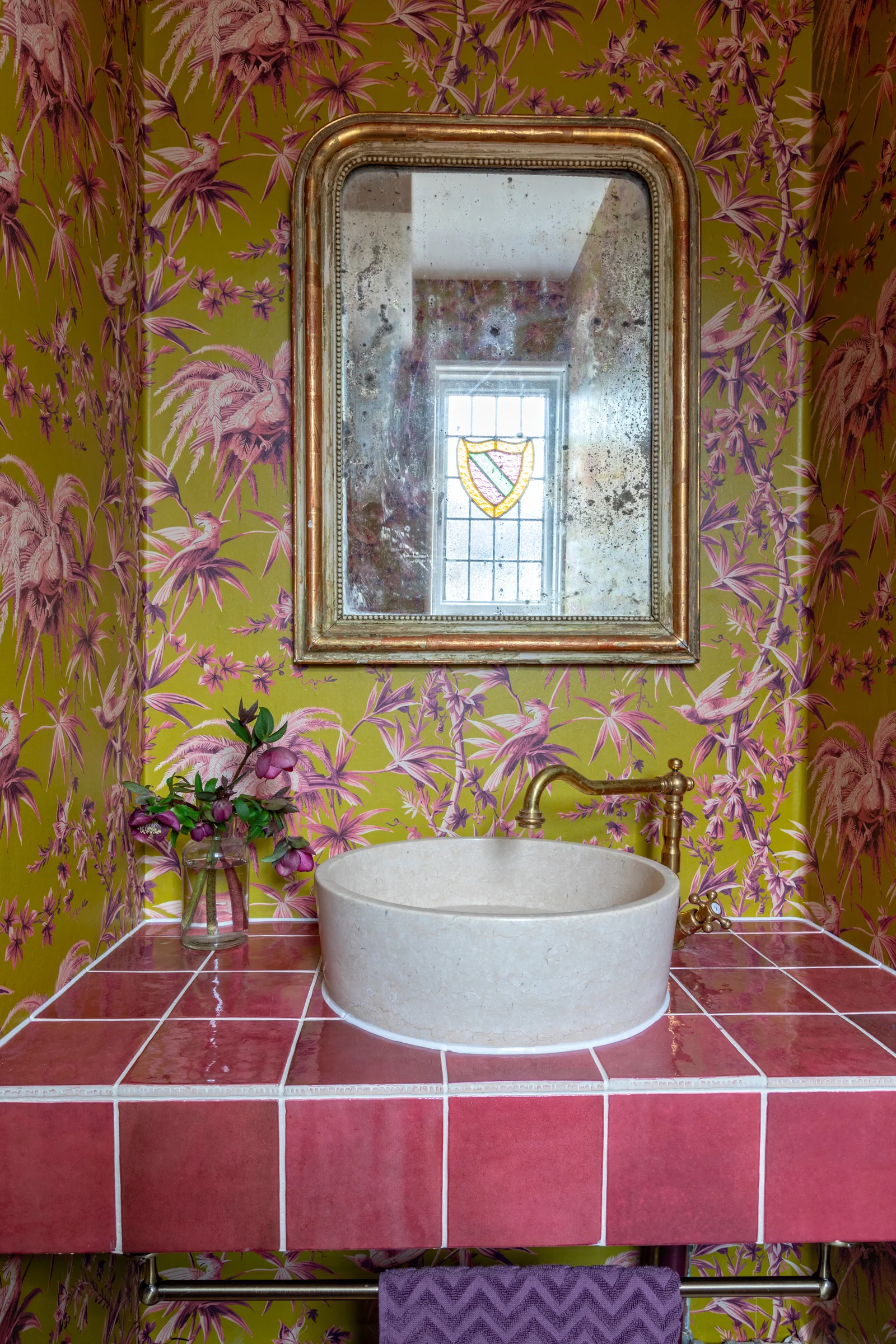Bold House of Hackney wallpaper covers the downstairs loo. Image credit - Anna Yanovski