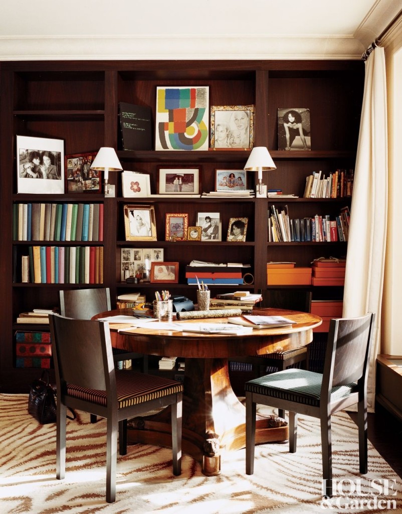 Orange Hermés boxes stored in a bookshelf for a bright pop of color 