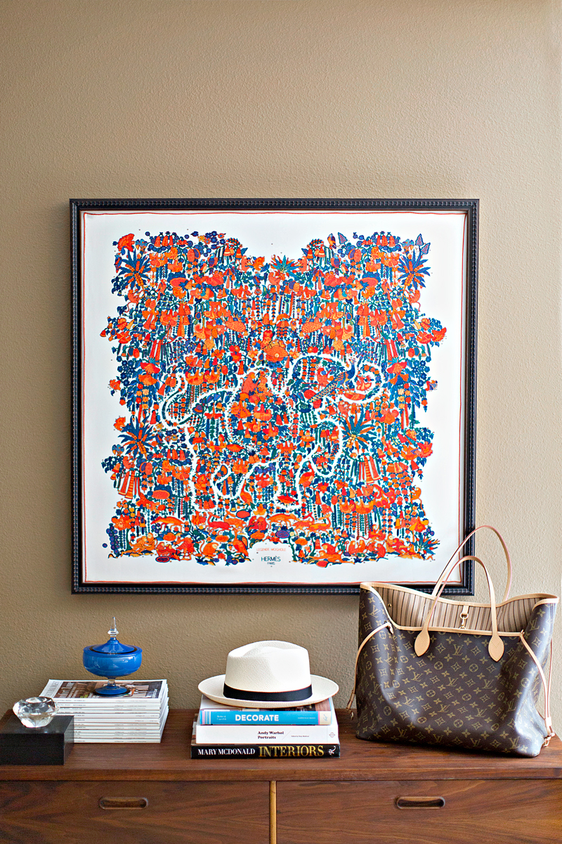 My favorite piece of art is this scarf that I had sewn to a mat and framed. It hangs above my 1950's dresser that I refinished about a year ago. 