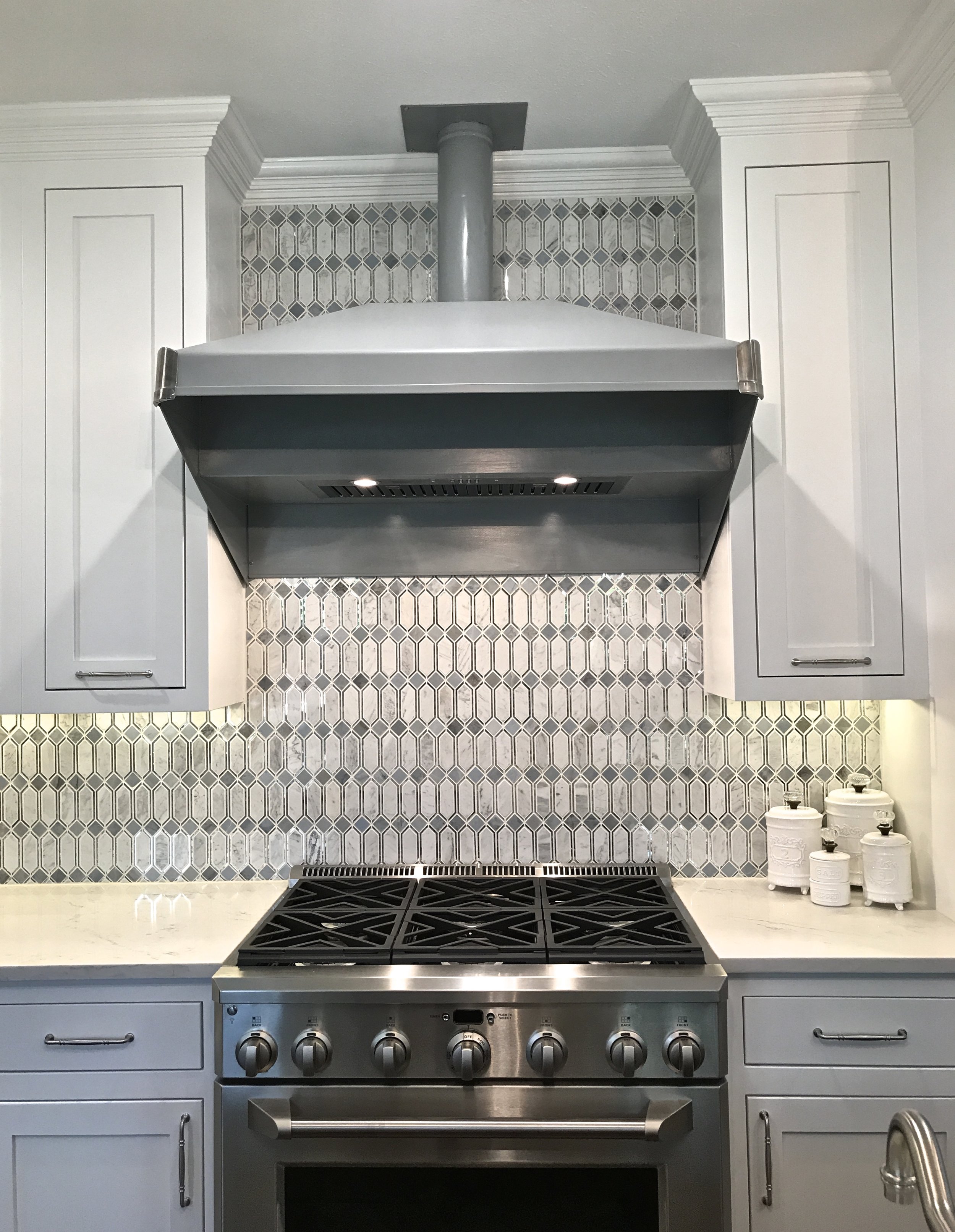Original range hood, diamond cut marble and mirror tile modeled after stained glass from the 1920's. 