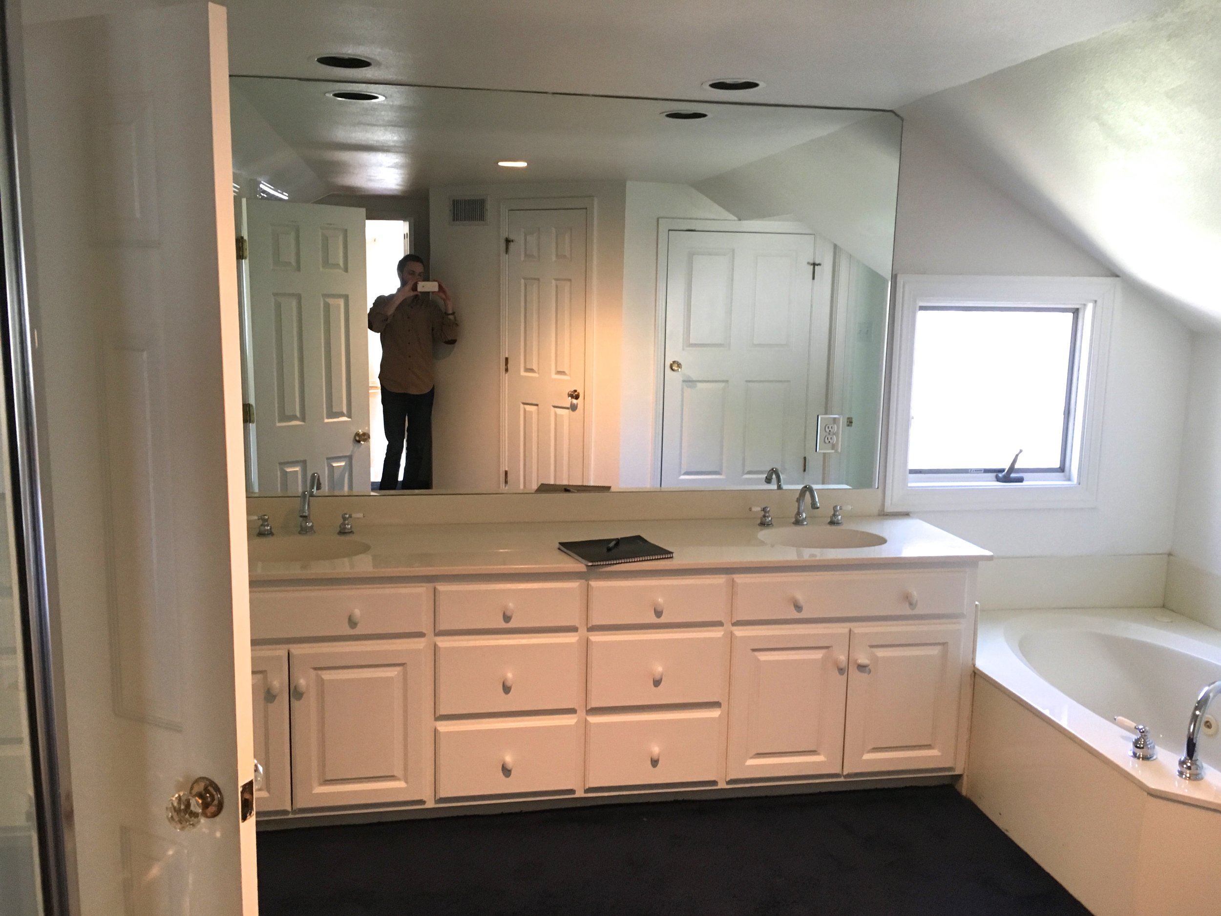 Before: The bath tub and shower were in separate locations, and the space was divided. Also, notice the navy blue carpet. Yikes! 