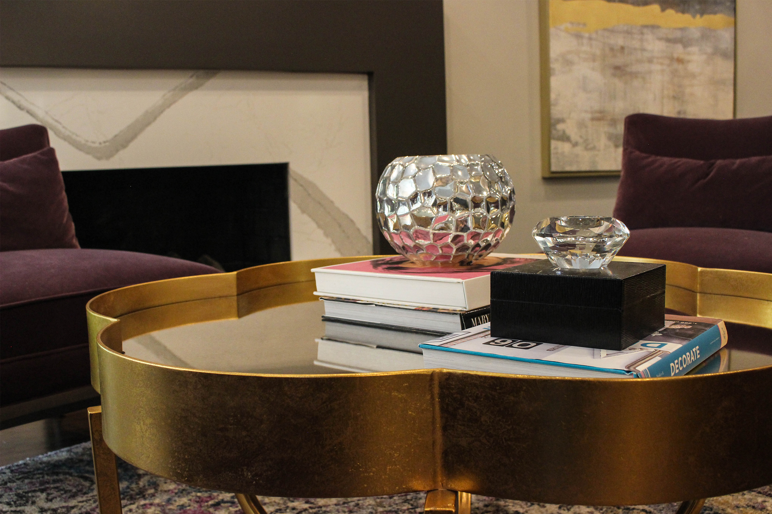 The gold leaf finished coffee table adds a unique feature to the space. 