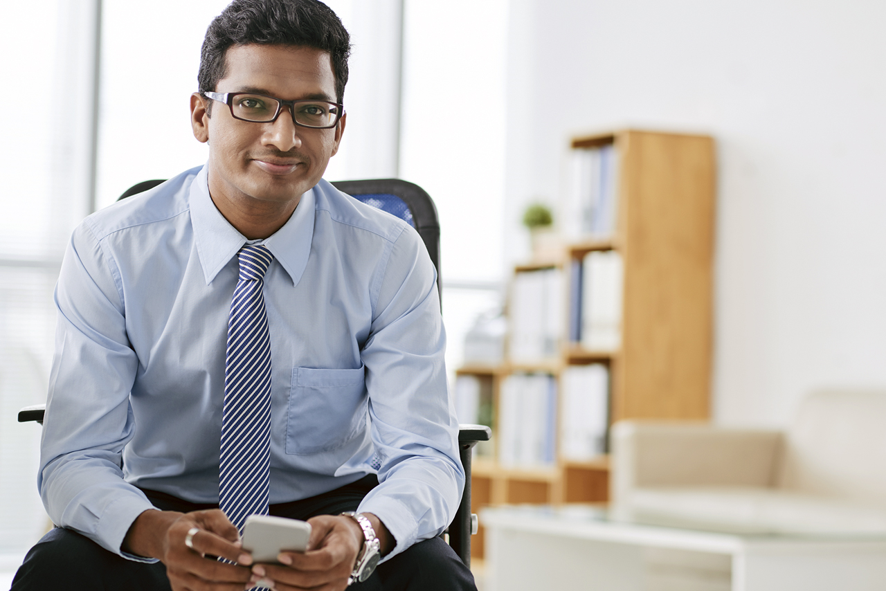 Smiling Indian businessman who hired Moss Search to recruit technology professionals.