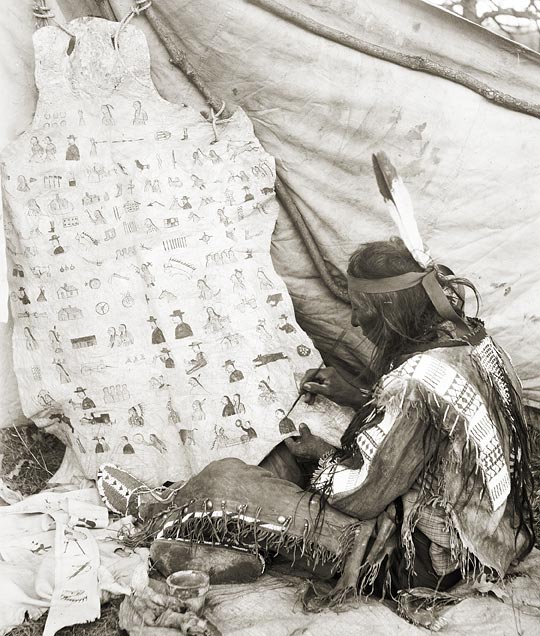 Sam Kills Two, also known as Beads, working on his winter count. Image courtesy Nebraska State Historical Society, John Anderson Collection (RG2969.PH:2-1).