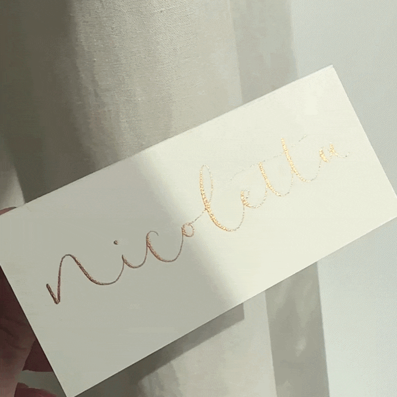 Ivory place name displaying the name 'nicoletta' in very shimmery gold pigment.