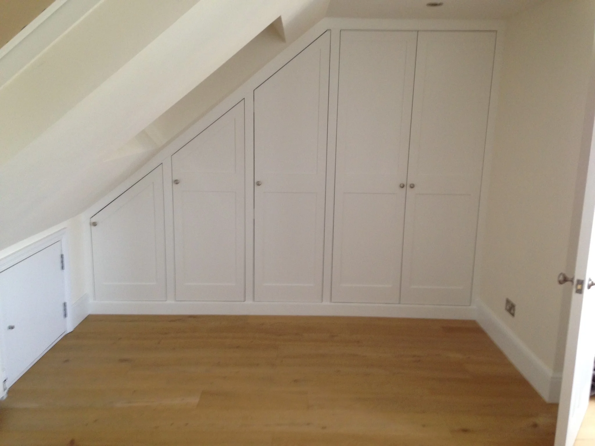 This contemporary Angled wardrobe utilizes difficult space in a loft room.