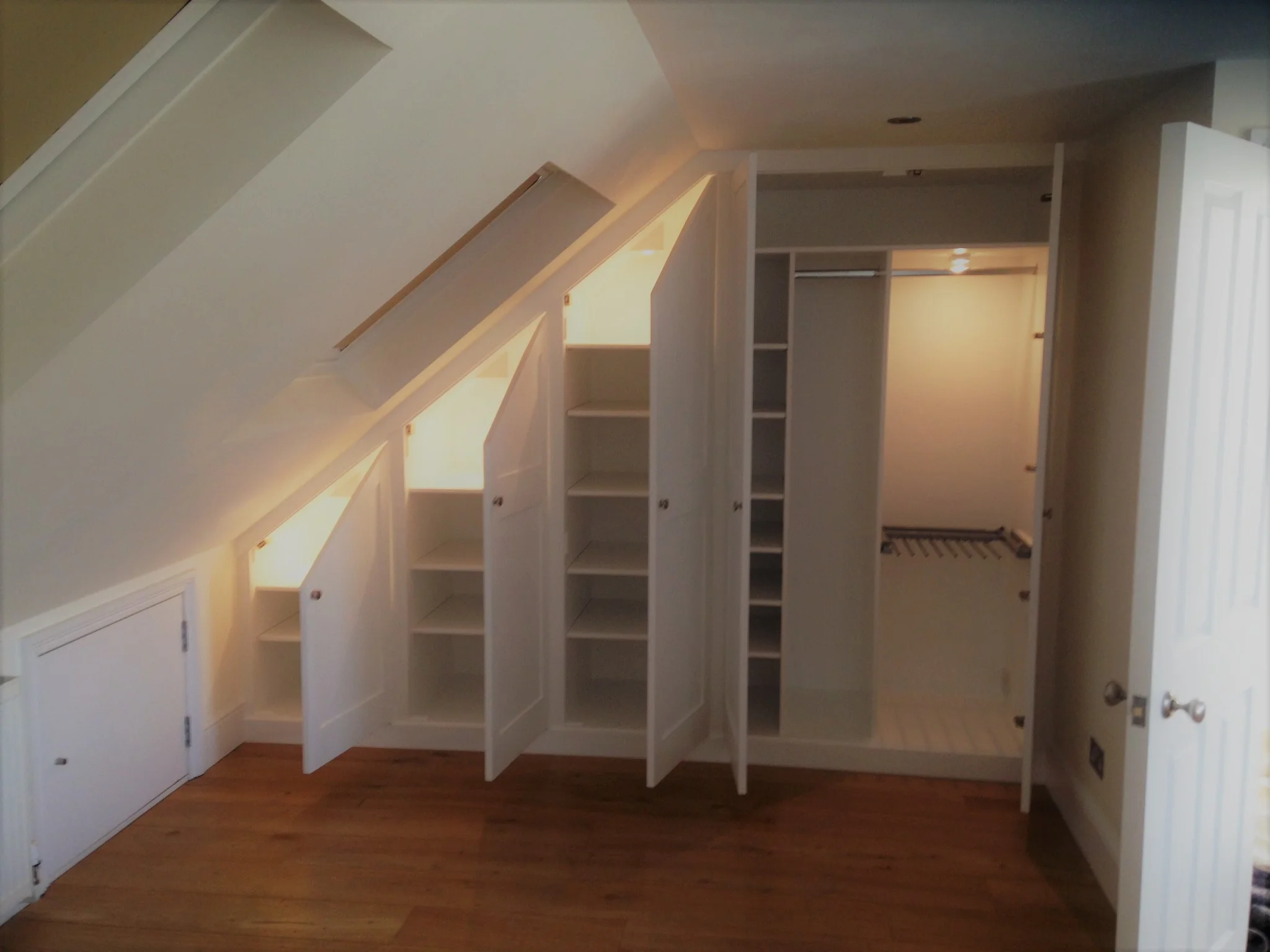 Angled wardrobe with Internal lighting on push latch sensors.