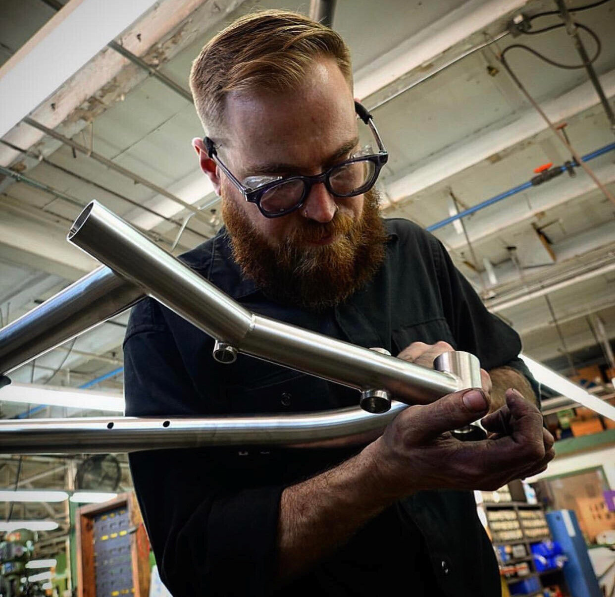 John T inspects a frame. The professional bike builders at Seven Cycles pay attention to every detail and get each right. They set the bar high in the bike building world.