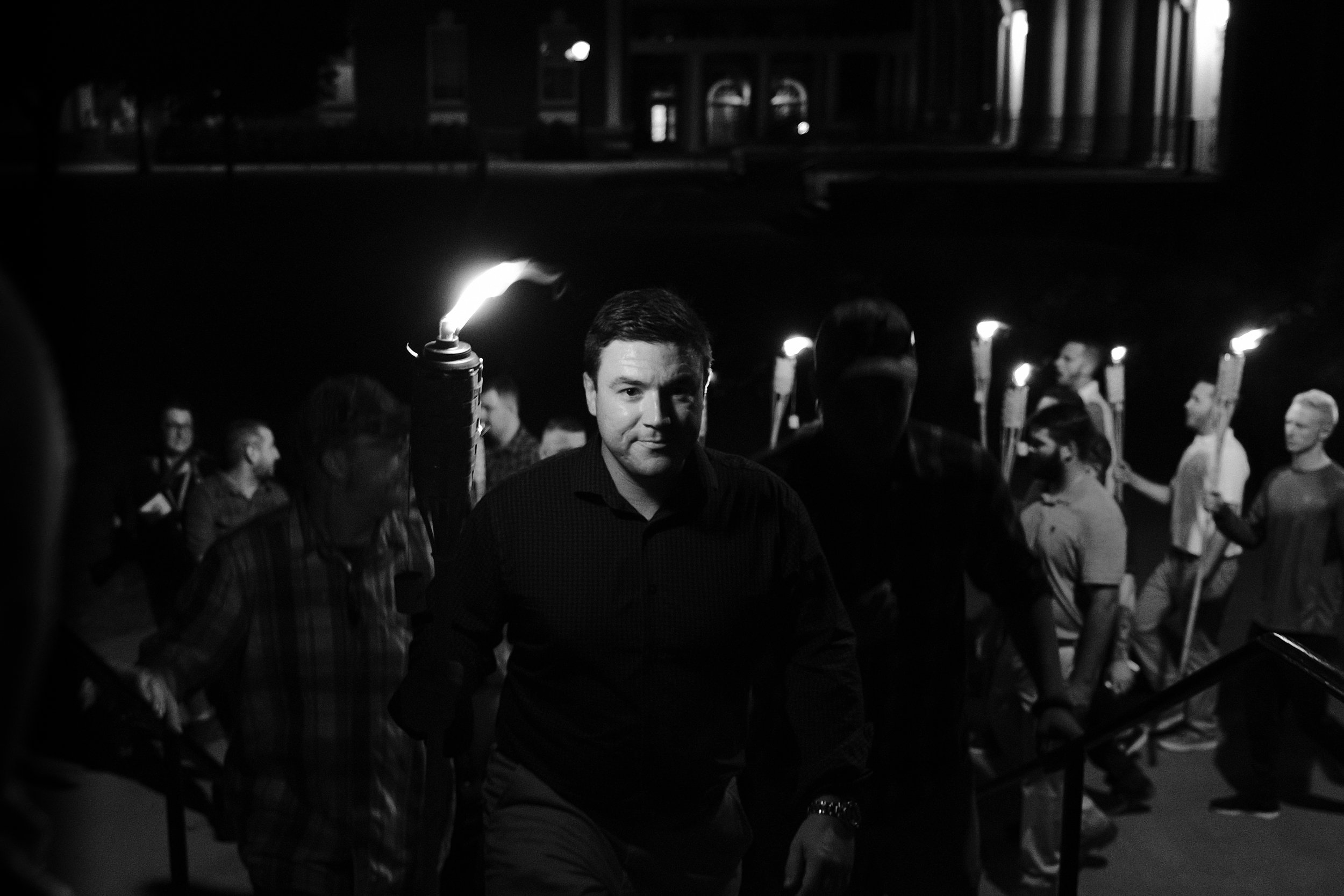  Jason Kessler (above) led the congregation as they moved haphazardly through the UVA campus. He was surrounded by a security detail and a handful of notable white supremacist celebrities including Richard Spencer, Evan McLaren, and Christopher Cantw