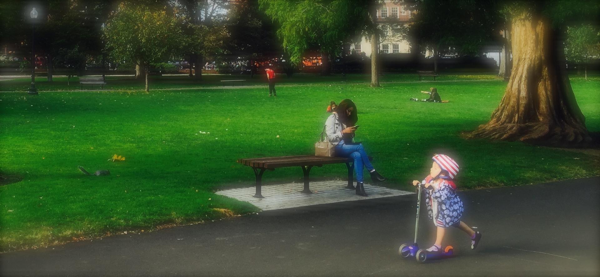 Texting and playing in Boston's Public Garden. Photo by Rick Holmes