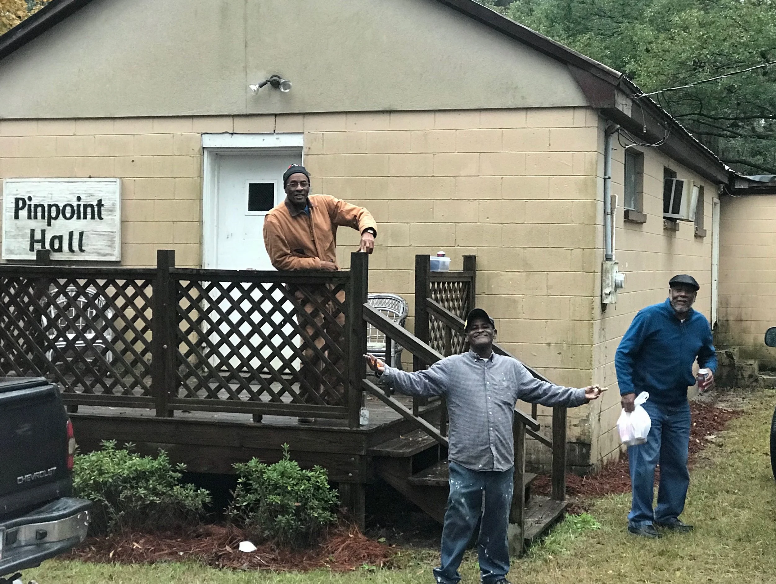 Three gentlemen of Pin Point outside the community's social center.