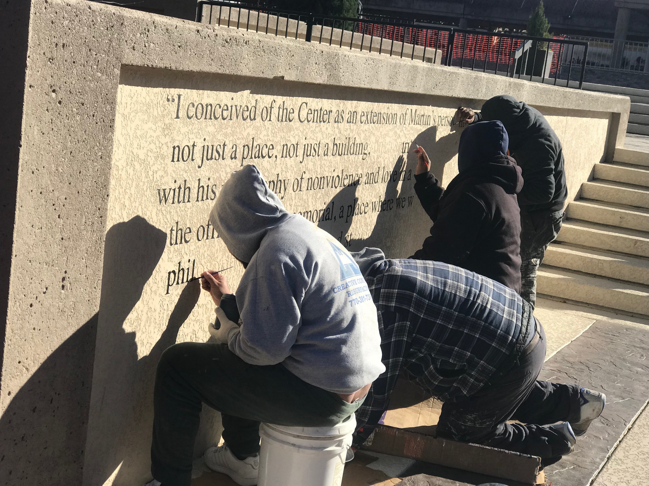  Workers repaint inscriptions at the Martin Luther King Jr. Center in Atlanta. Photo by Rick Holmes   