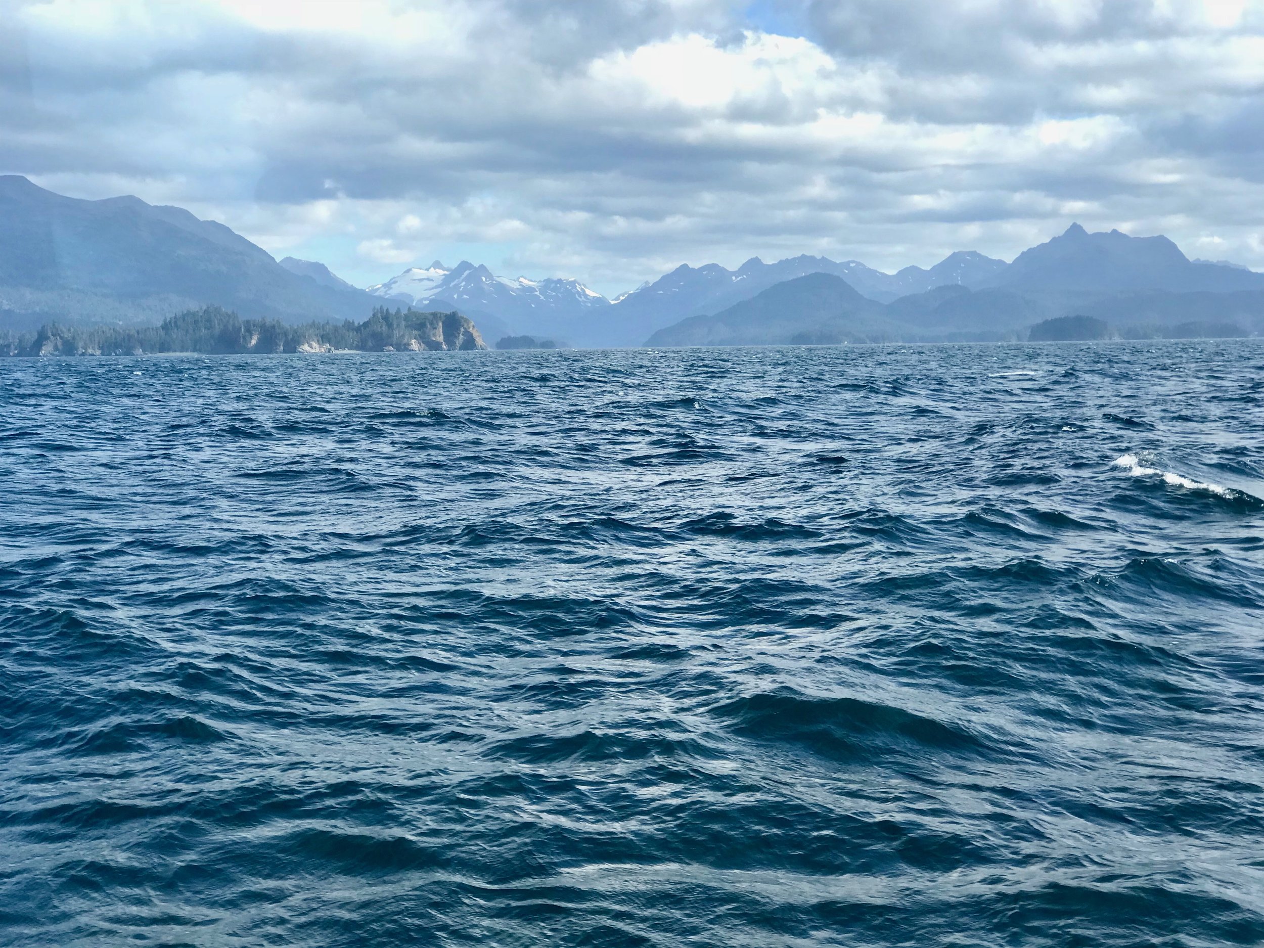 Crossing Katchemak Bay. How big is Alaska? The snow on the mountains marks the edge of an ice field the size of Rhode Island.