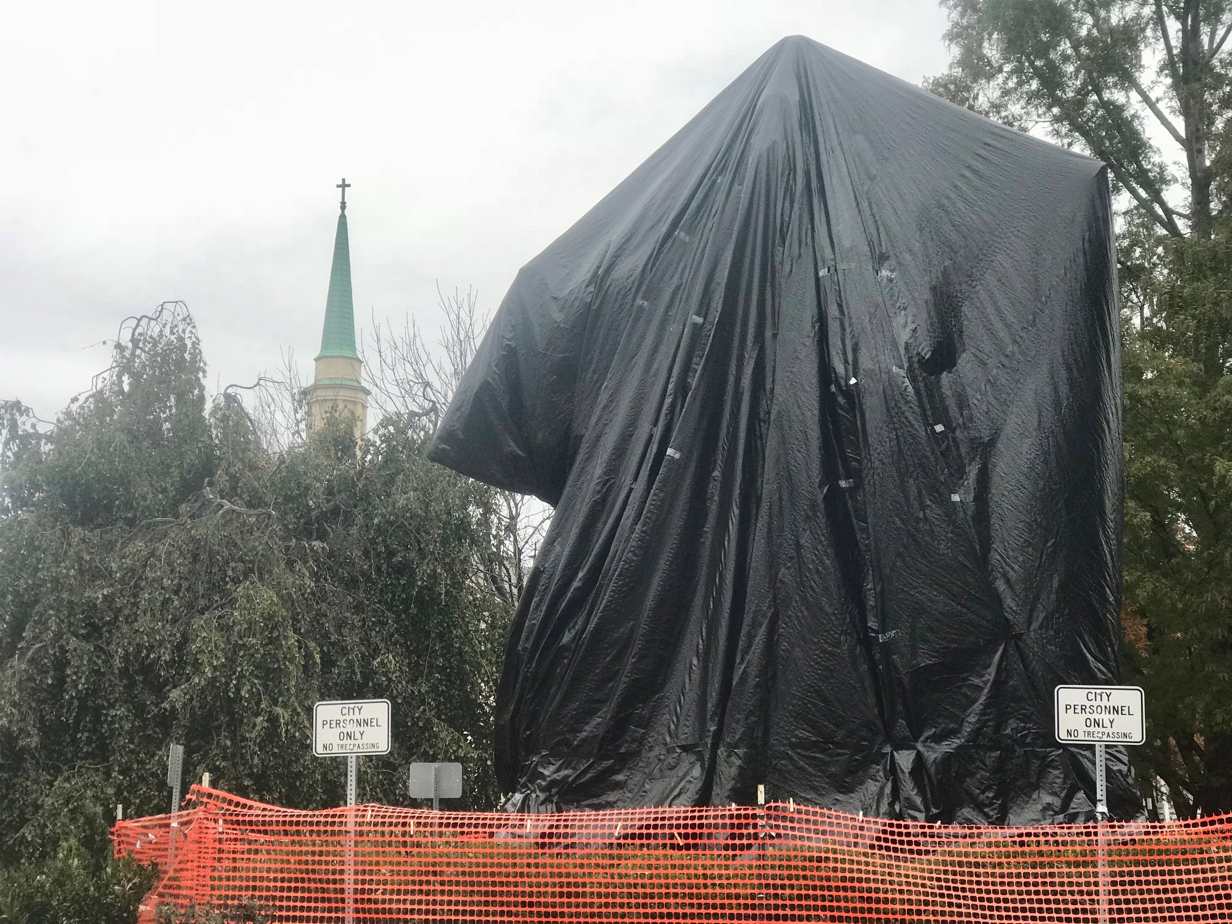  A plastic shroud covers the statue of Robert E. Lee in Charlottesville, Va., the subject of litigation and protests. 