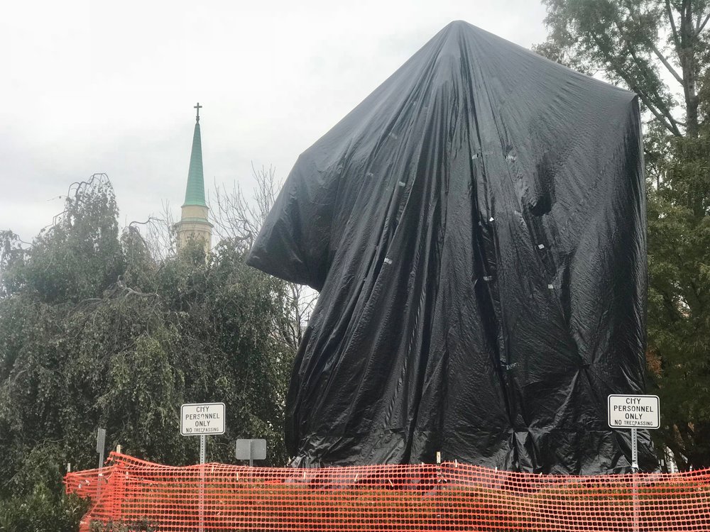  A plastic shroud covers the statue of Robert E. Lee in Charlottesville, Va., the subject of litigation and protests. 