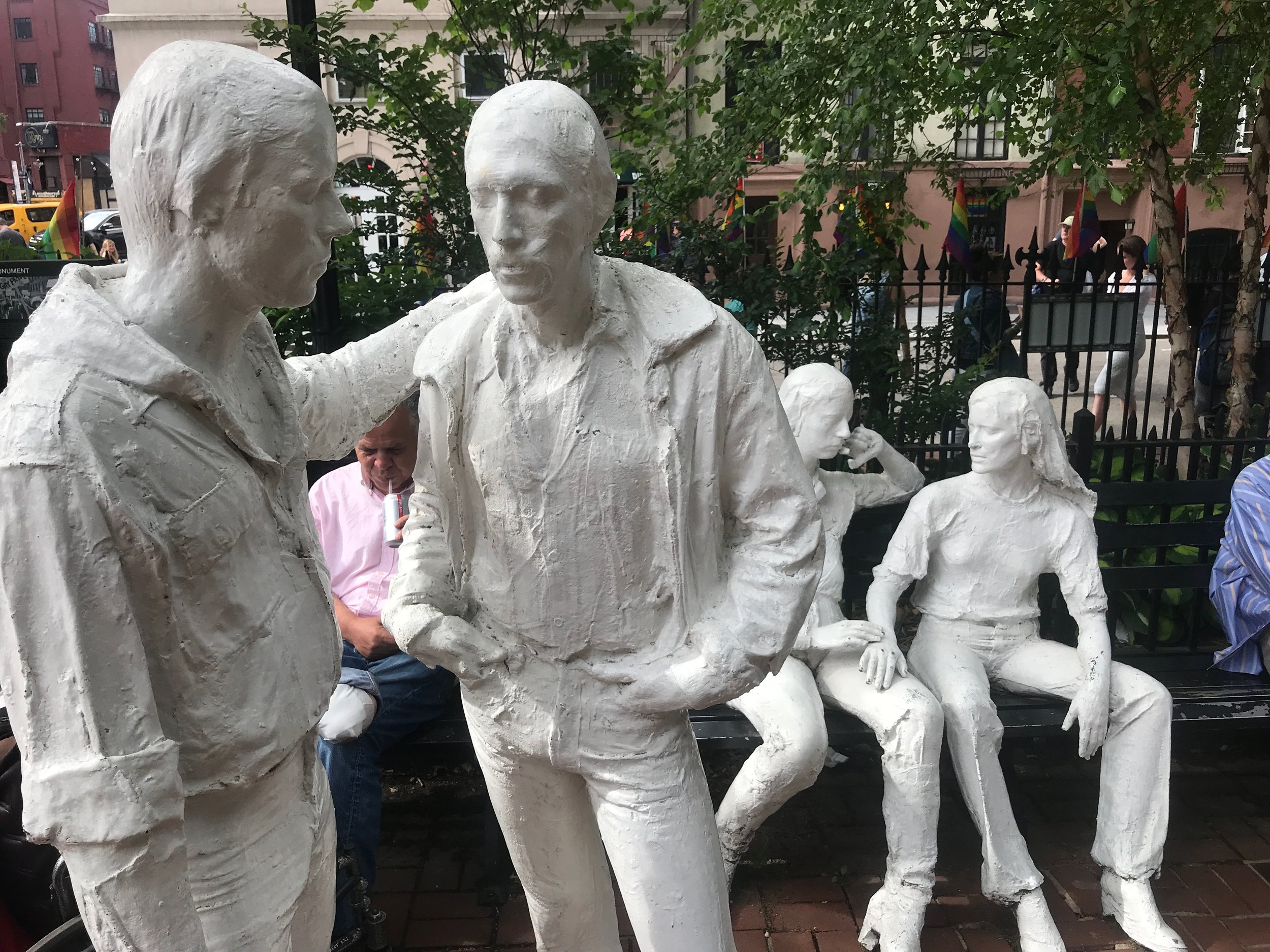  Rainbow flags, sculptures and visitors at the former Sheridan Square in New York's Greenwich Village, which is now part of the Stonewall National Monument. 