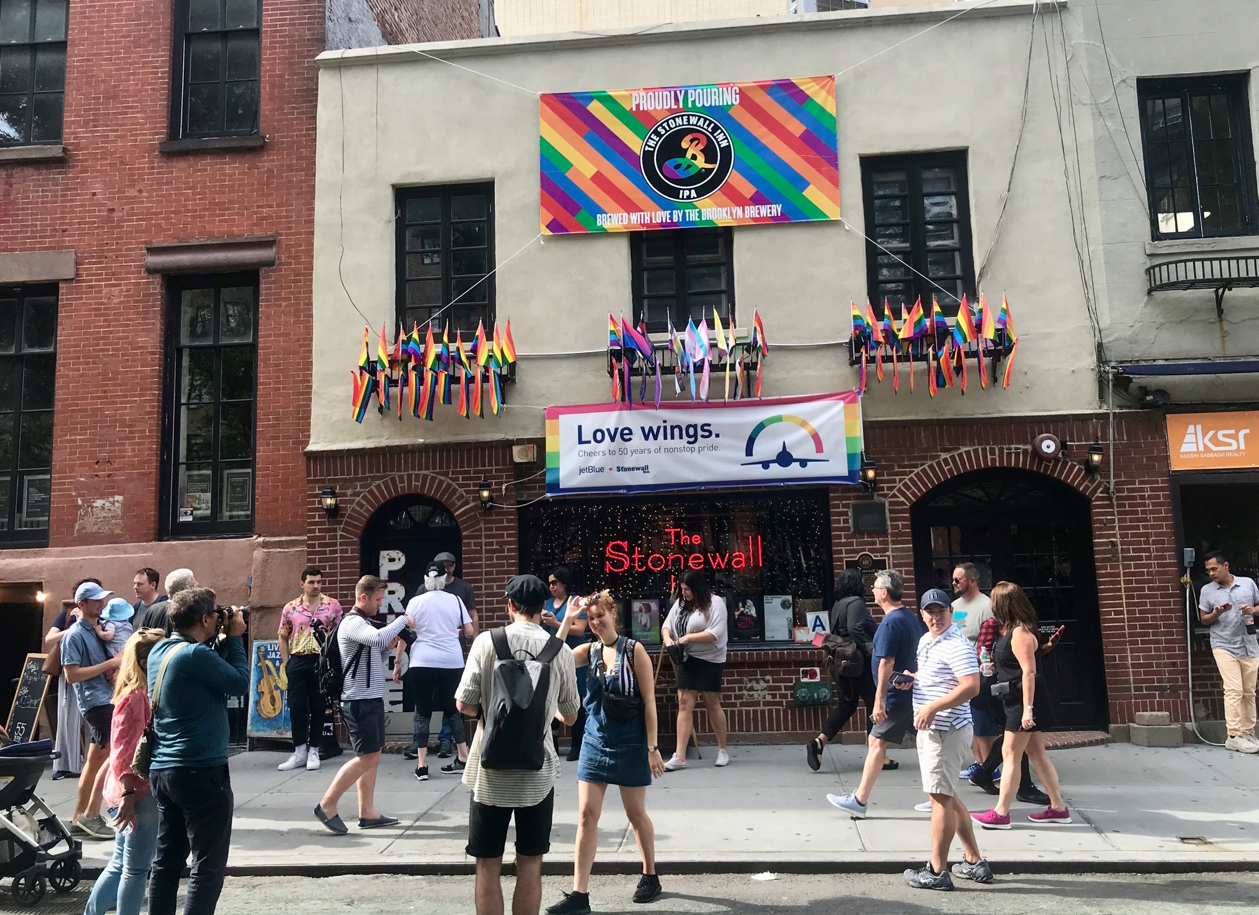  Tourists mill around New York's Stonewall Inn, the dive bar that was the site of street clashes in 1969 that helped launch the gay rights movement. 