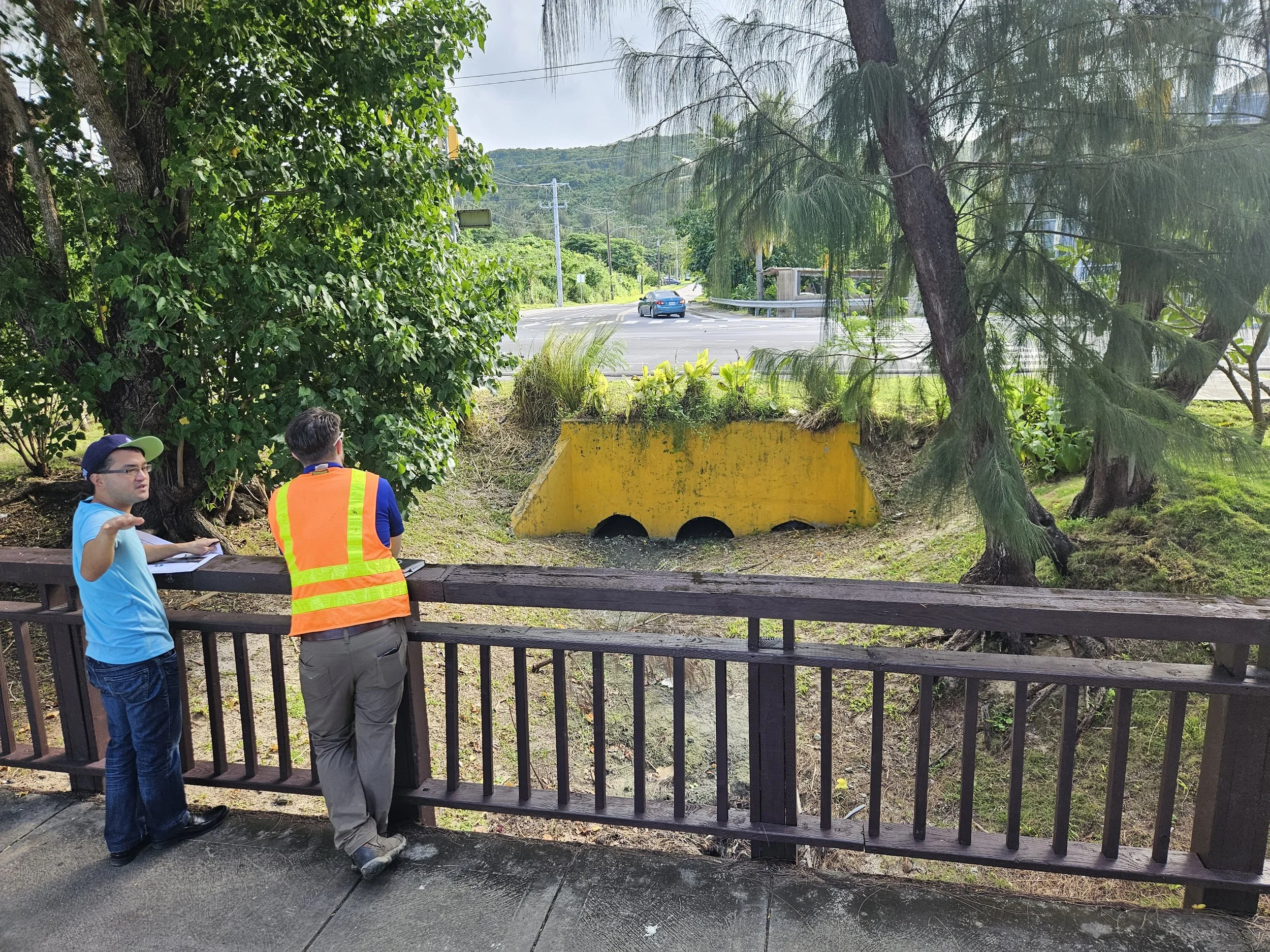 Stormwater engineers from Horsley Witten Group and Hofschneider Engineering Corporation discuss possible design interventions with the existing stormwater outfall at Chalan Laulau.