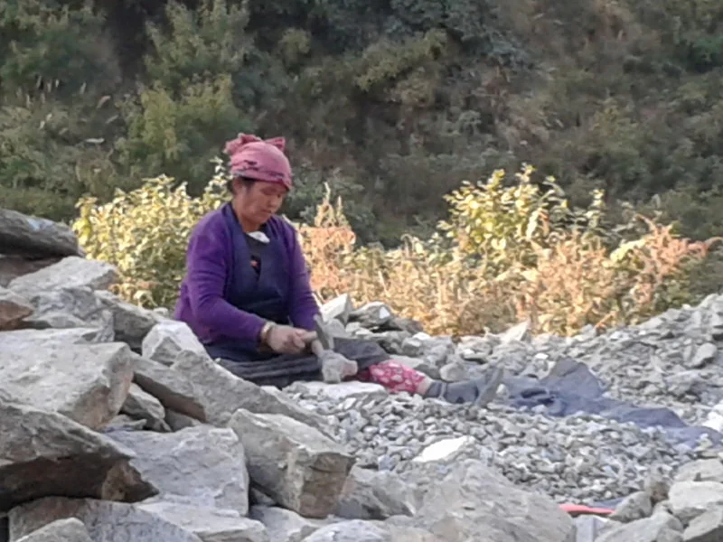 Rocks are hammered into the right shape and size for construction