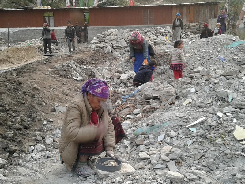 Women are employed to help rebuild the school for their children