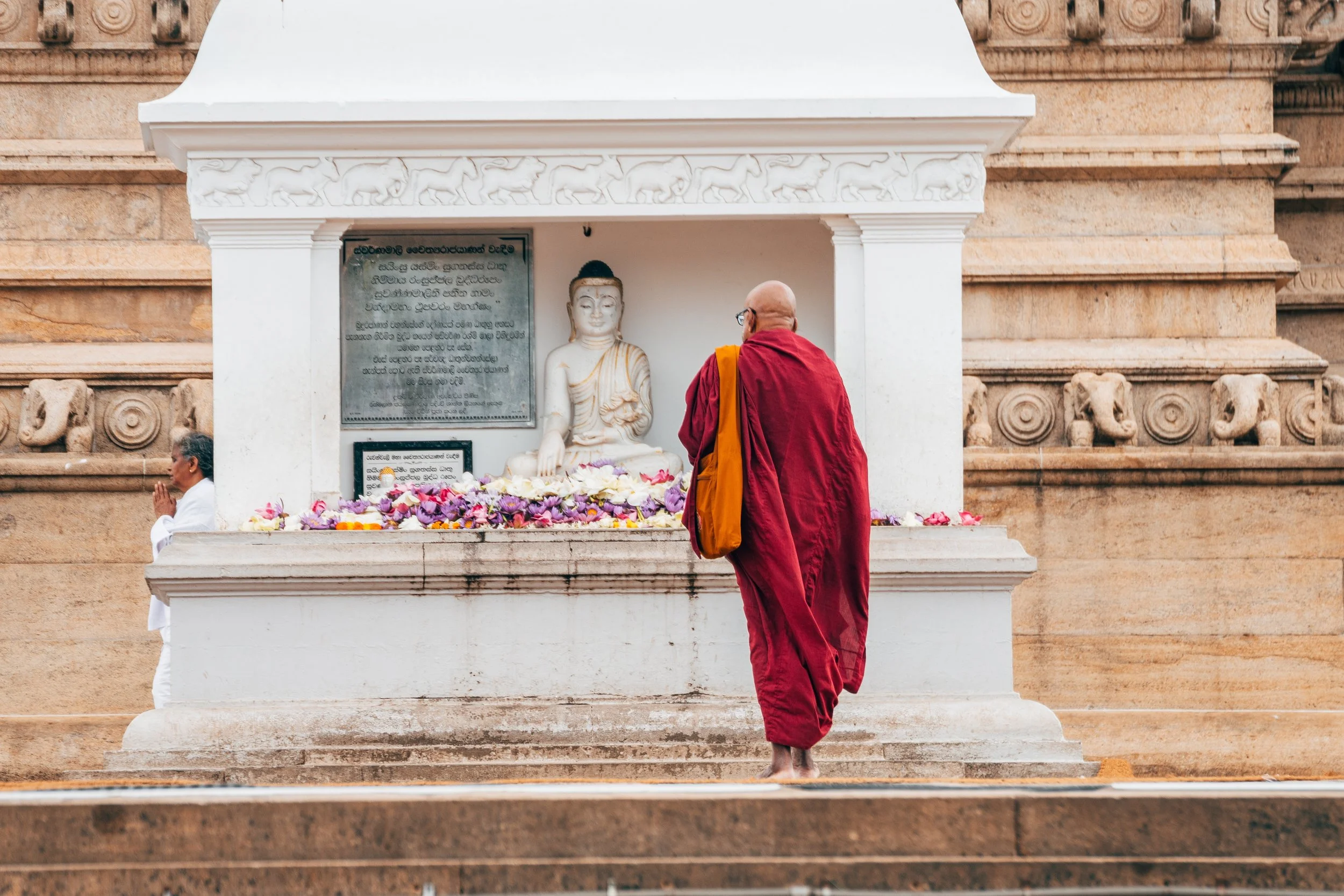 shutterstock_2388278513 Monk walking Anuradhapura Temple Sri Lanka.jpg