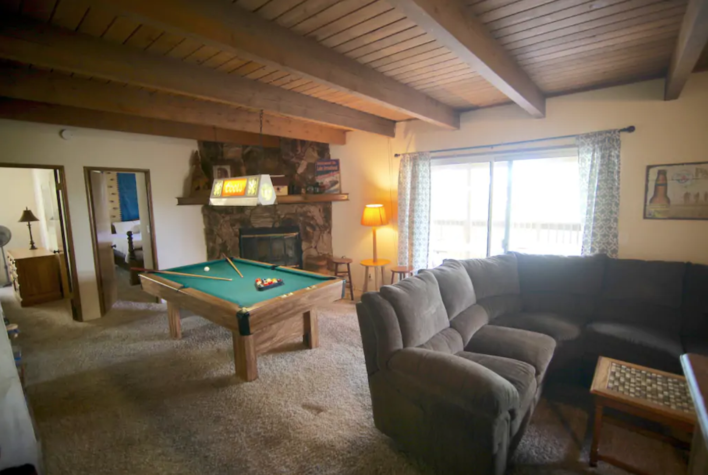 Game room with pool table and 60" flat screen TV.